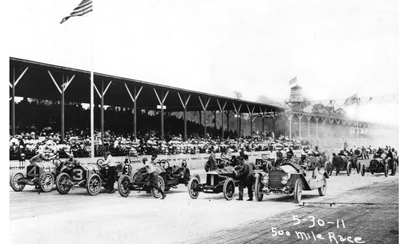 a group of people in cars on a track