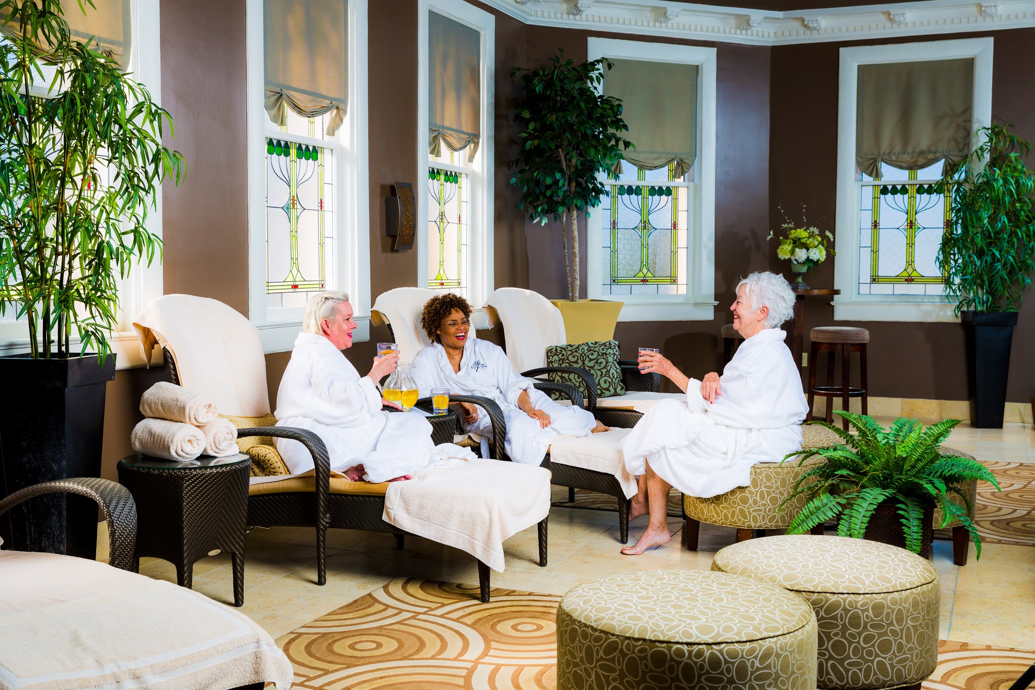 a group of women in white robes sitting in chairs