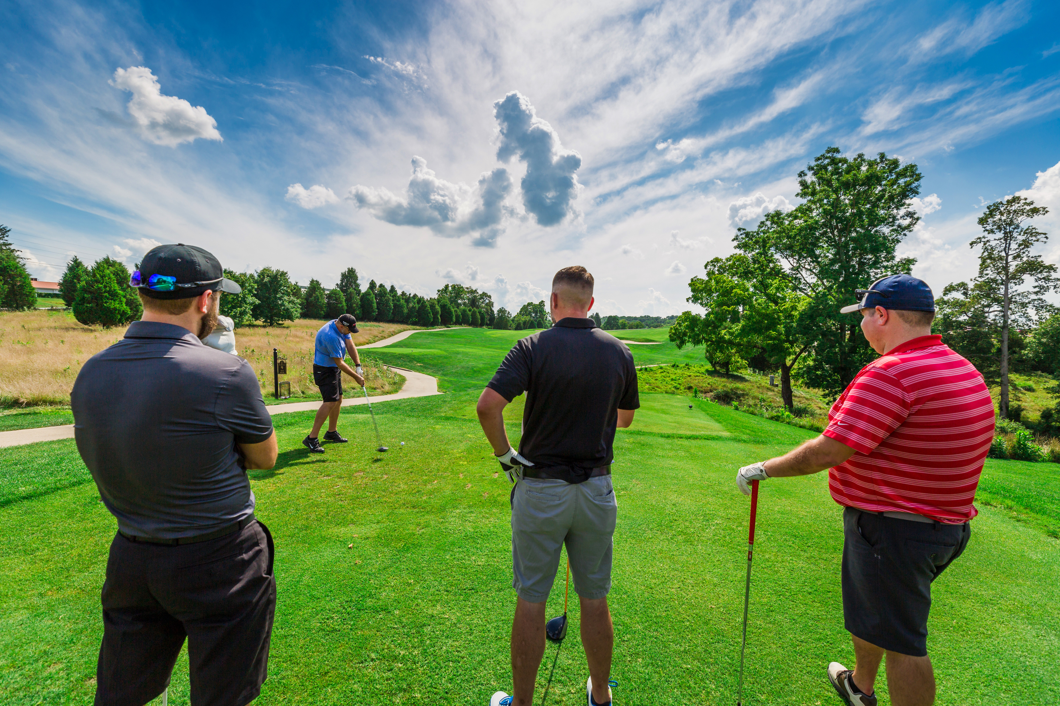 a group of men playing golf