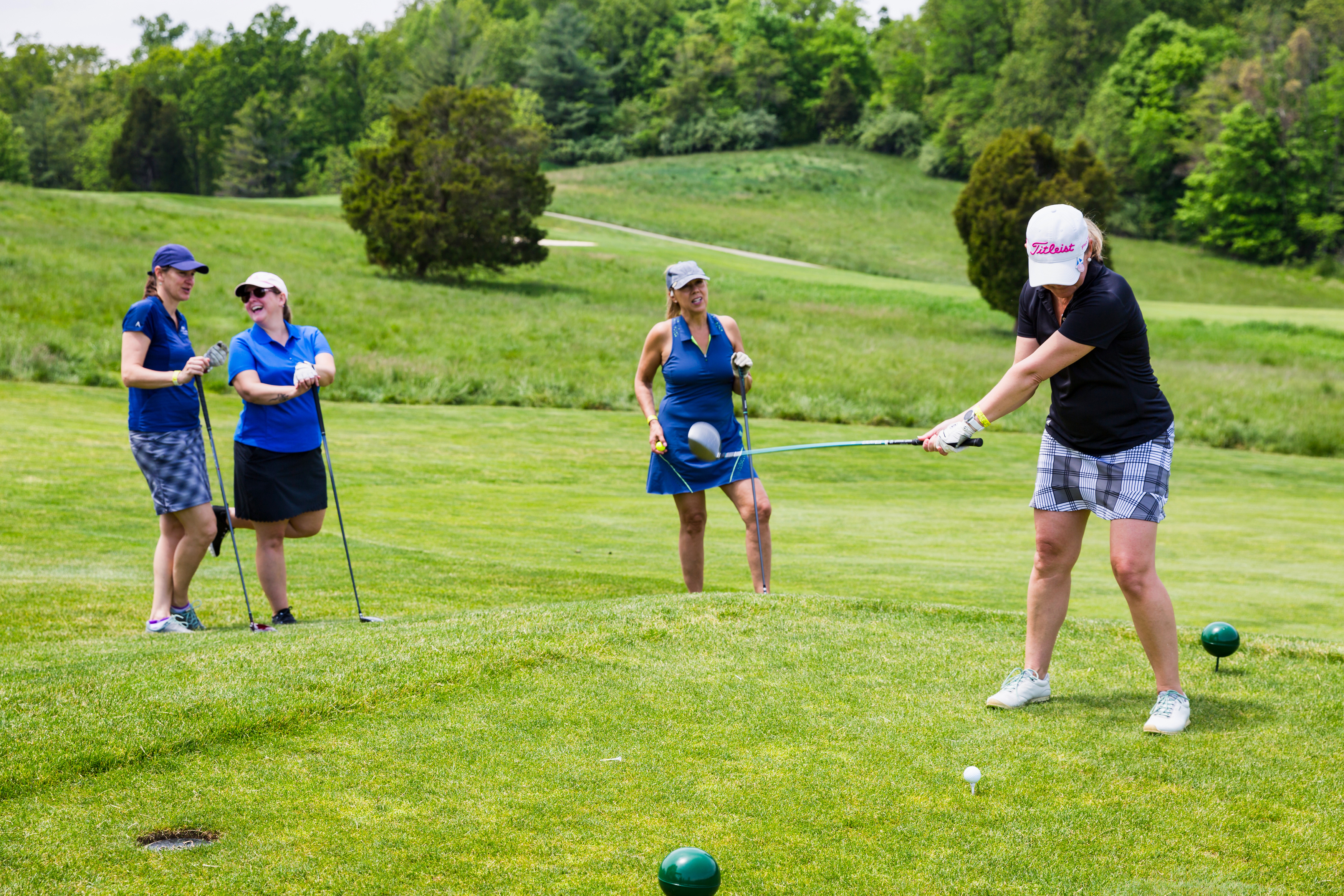 a group of women playing golf