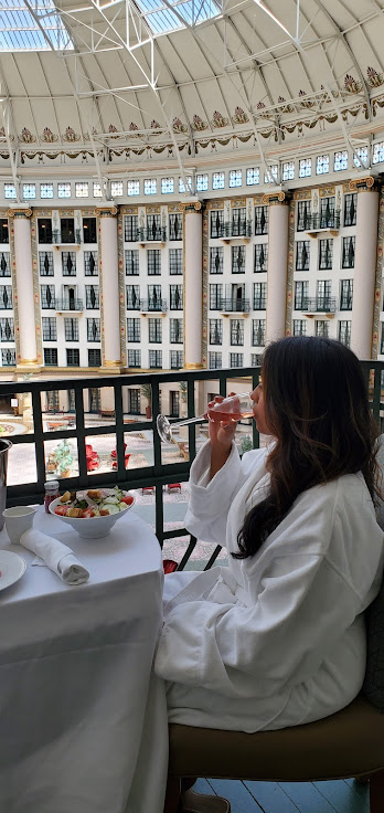 woman having brunch on her hotel balcony