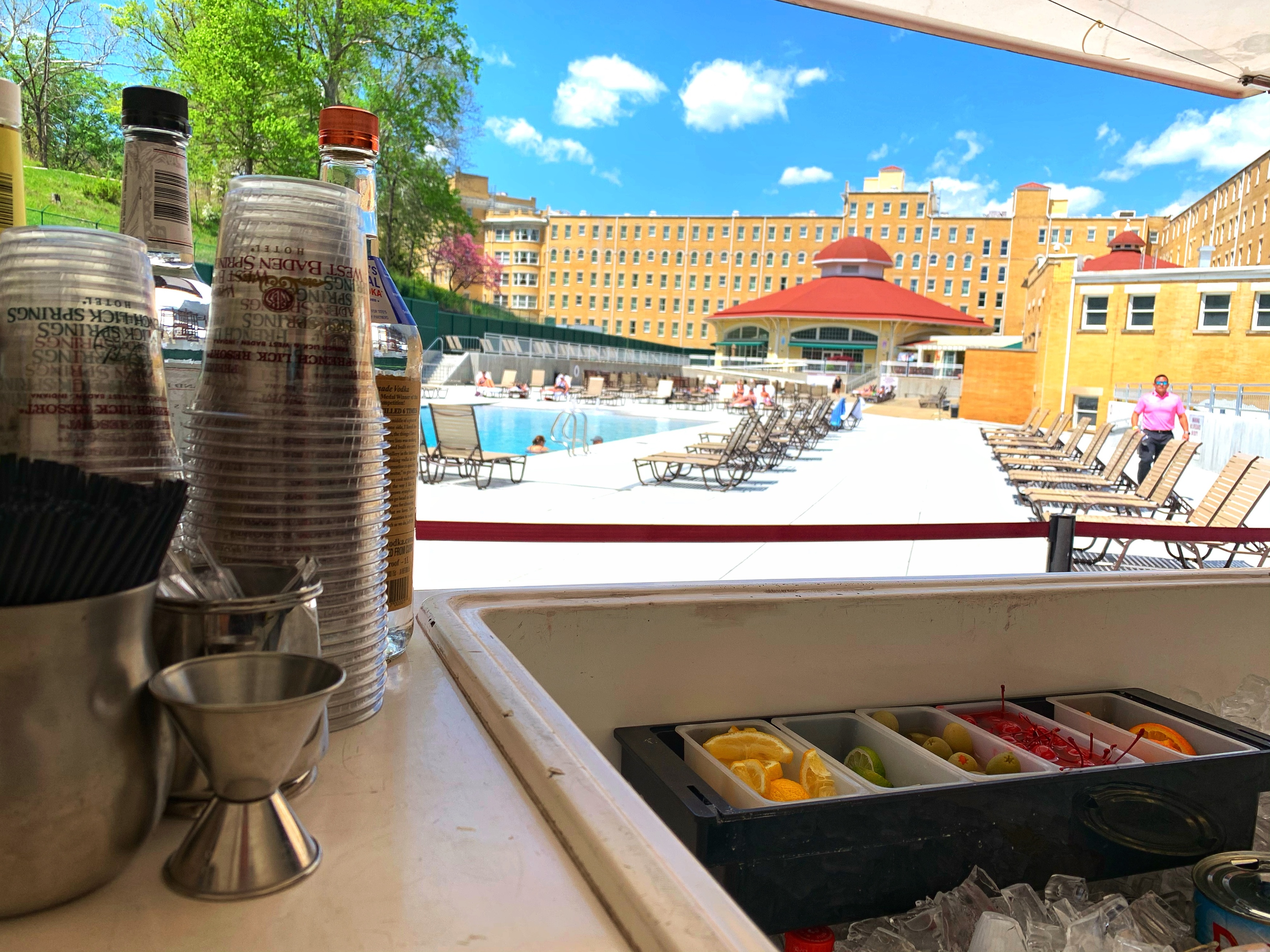 a pool with a building and a bar with a pool and a building