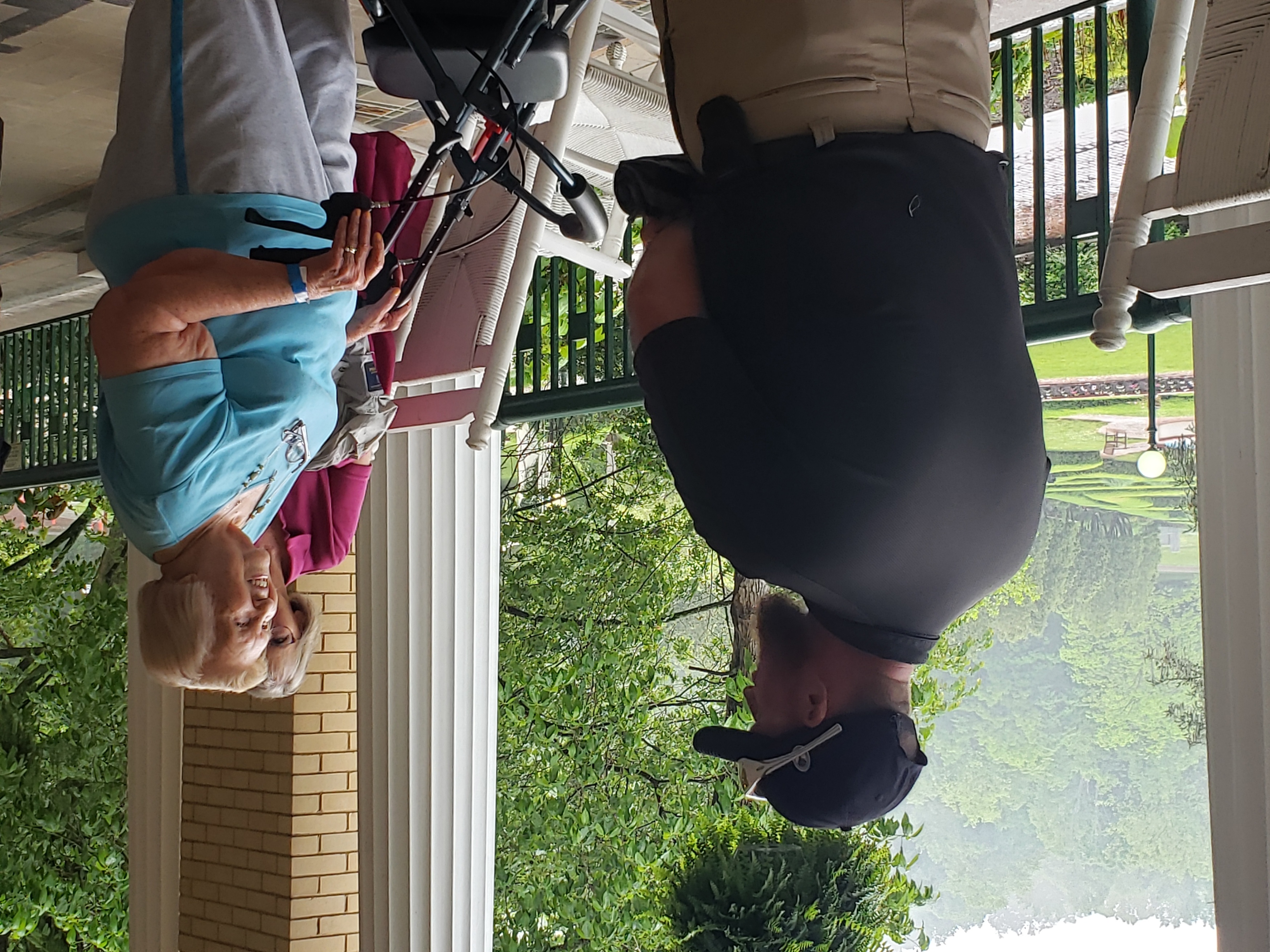 a man talking to a woman on a porch