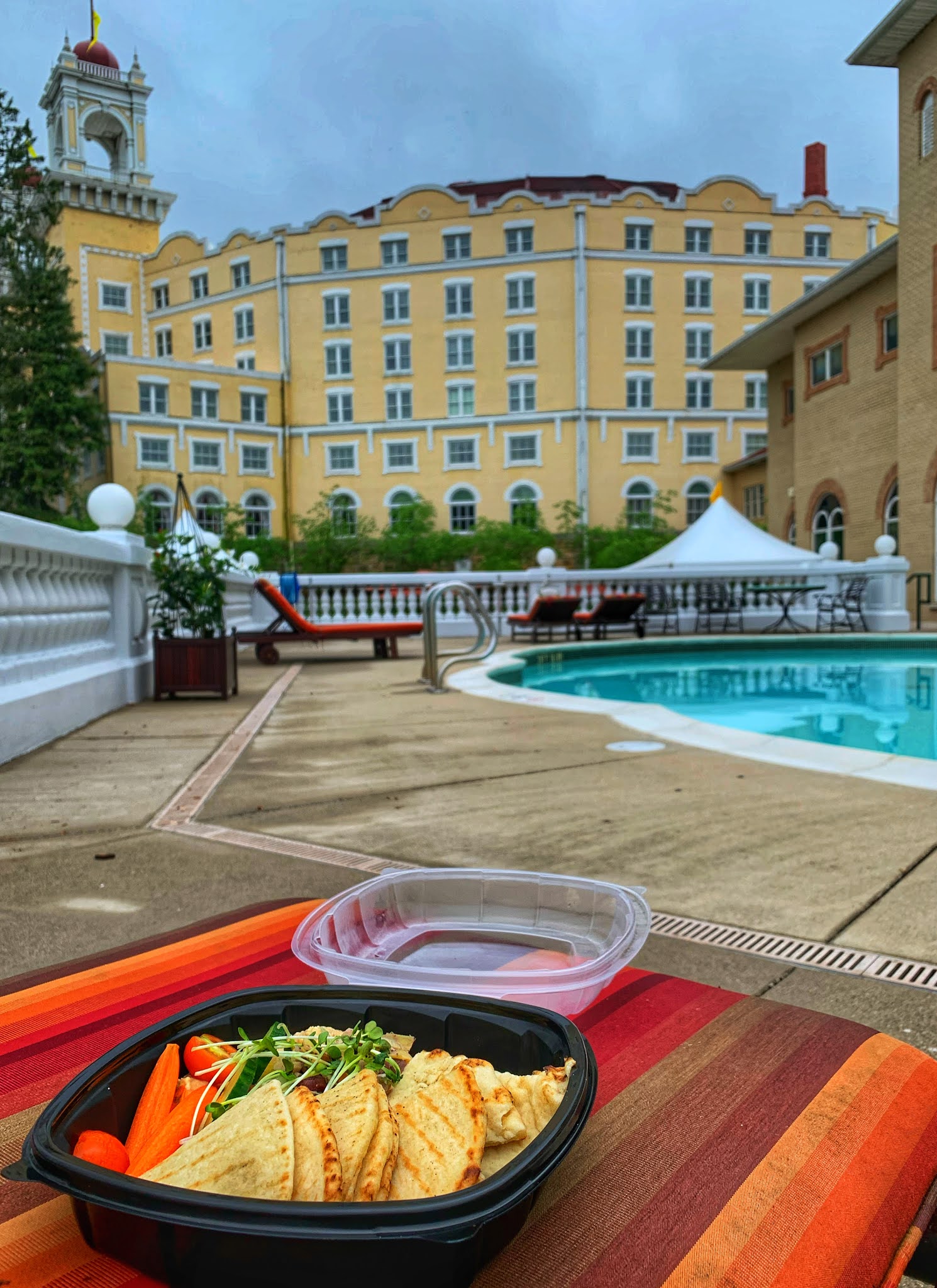a food on a table by a pool