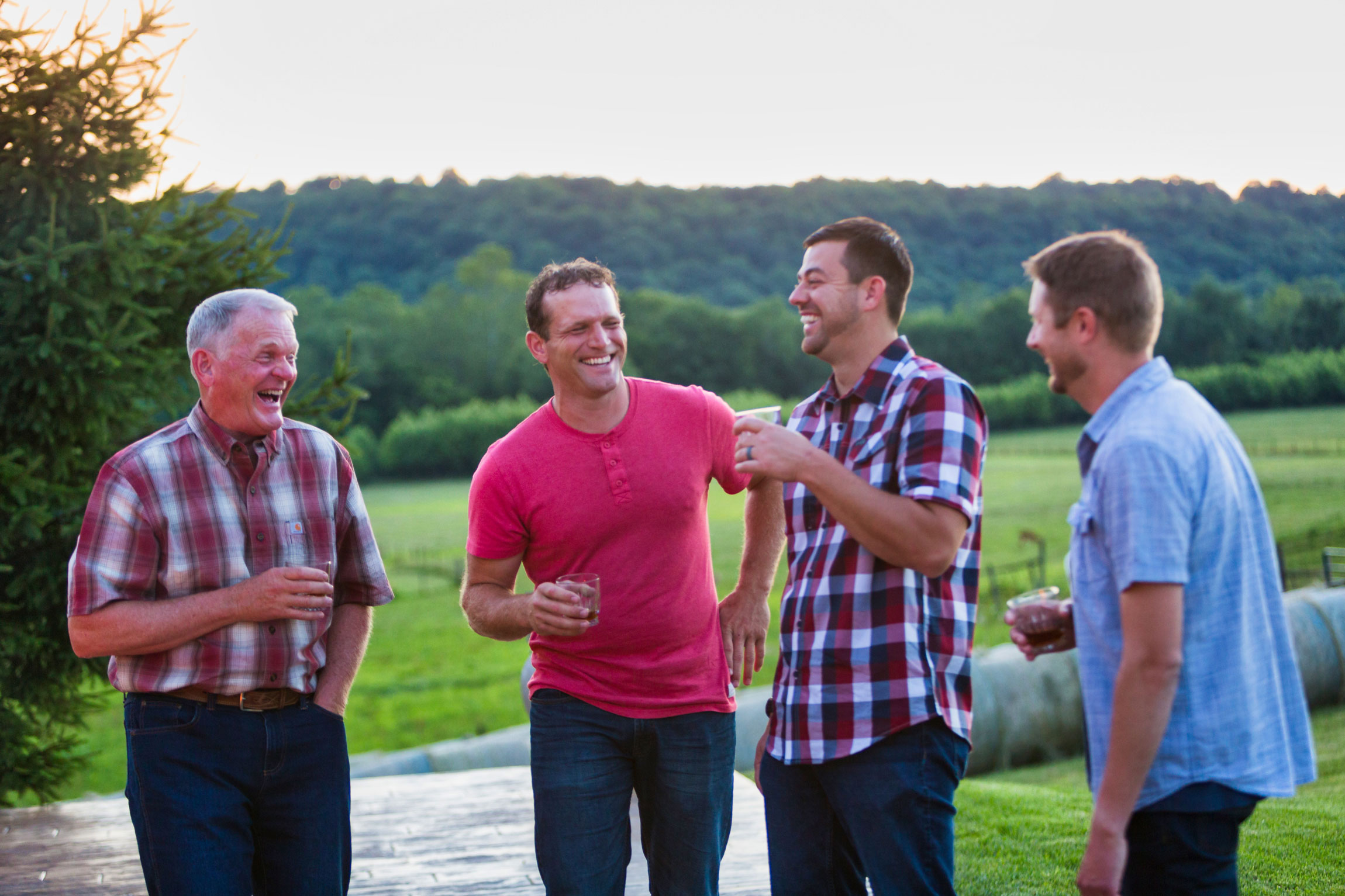 a group of men laughing and drinking