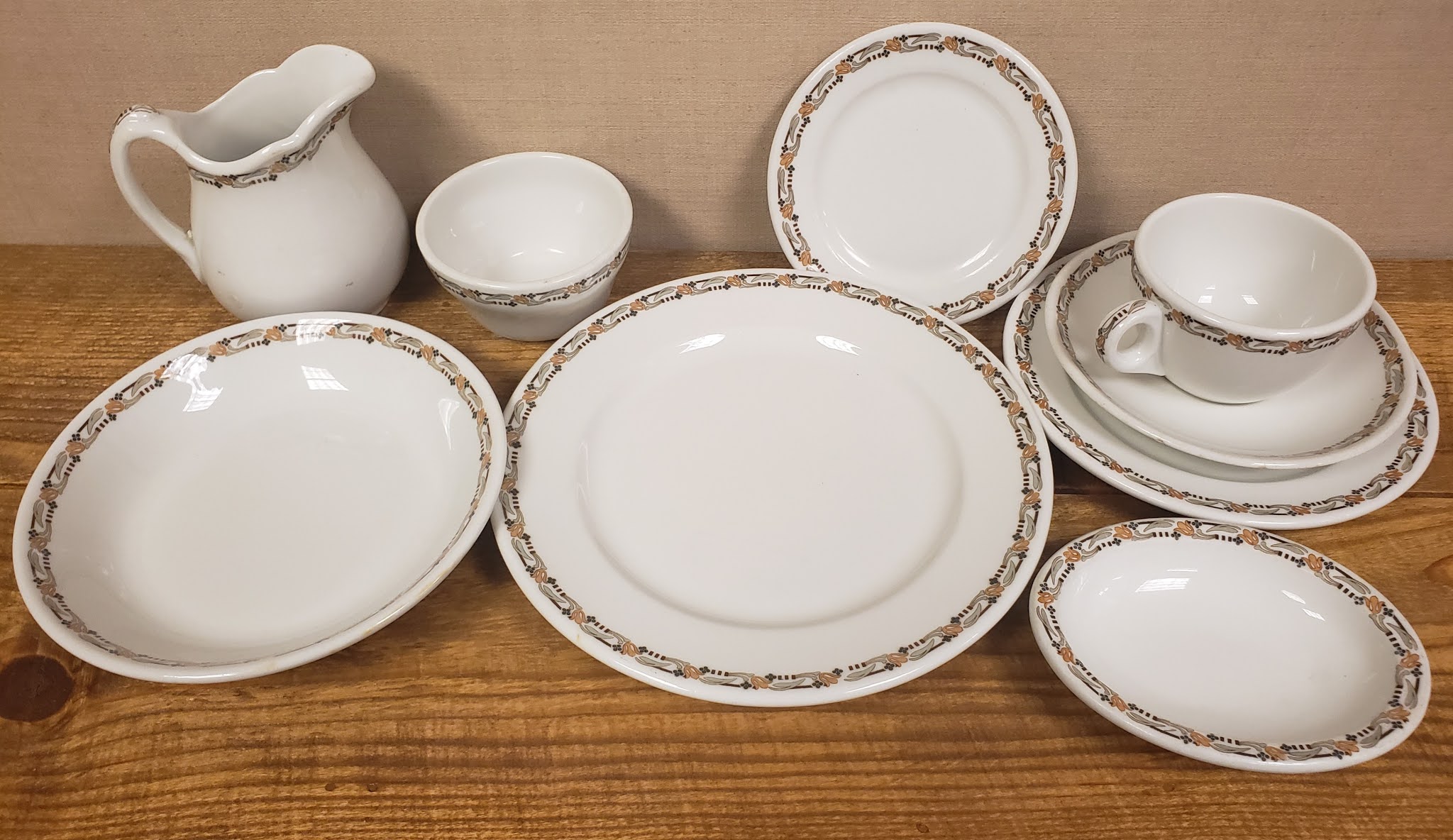 a group of white plates and cups