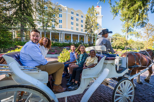 Family riding in carriage in french lick