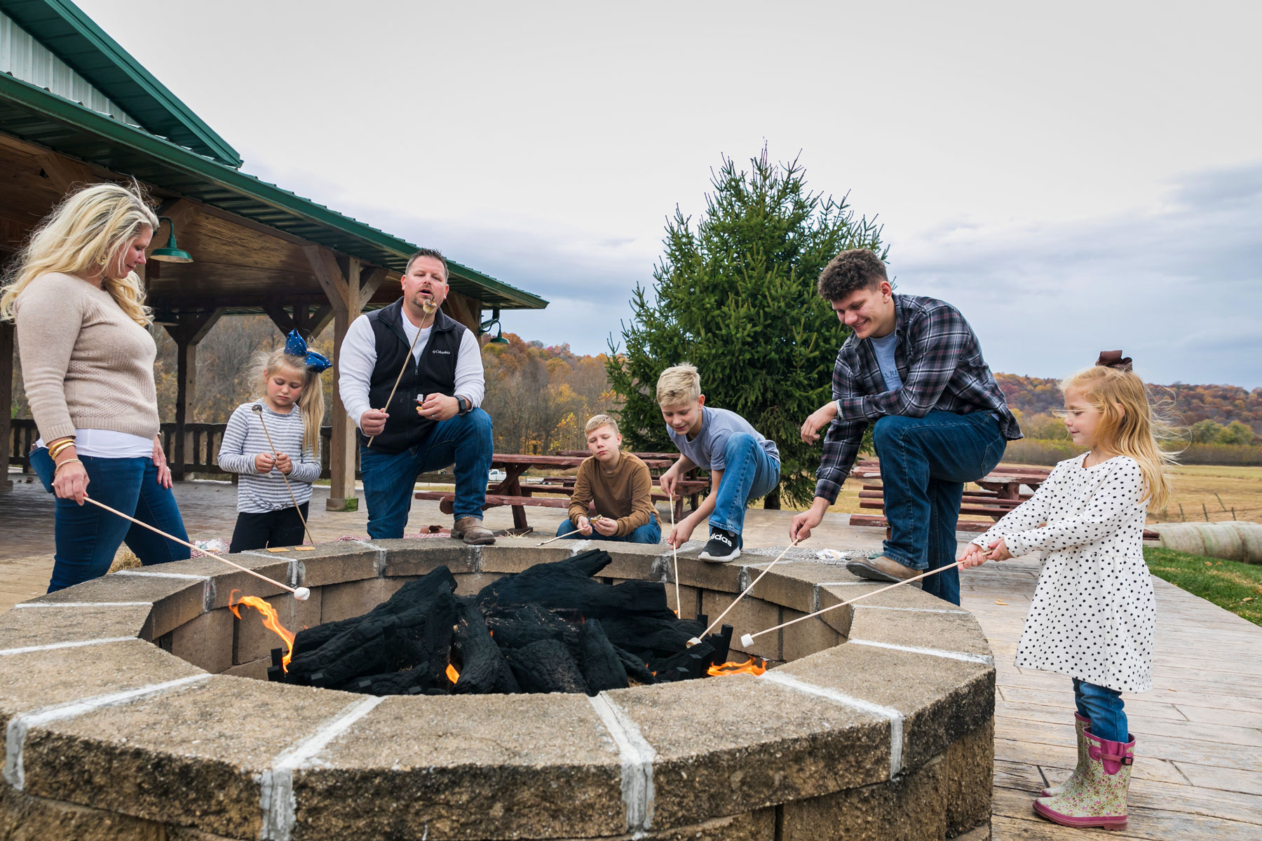 a group of people around a fire pit