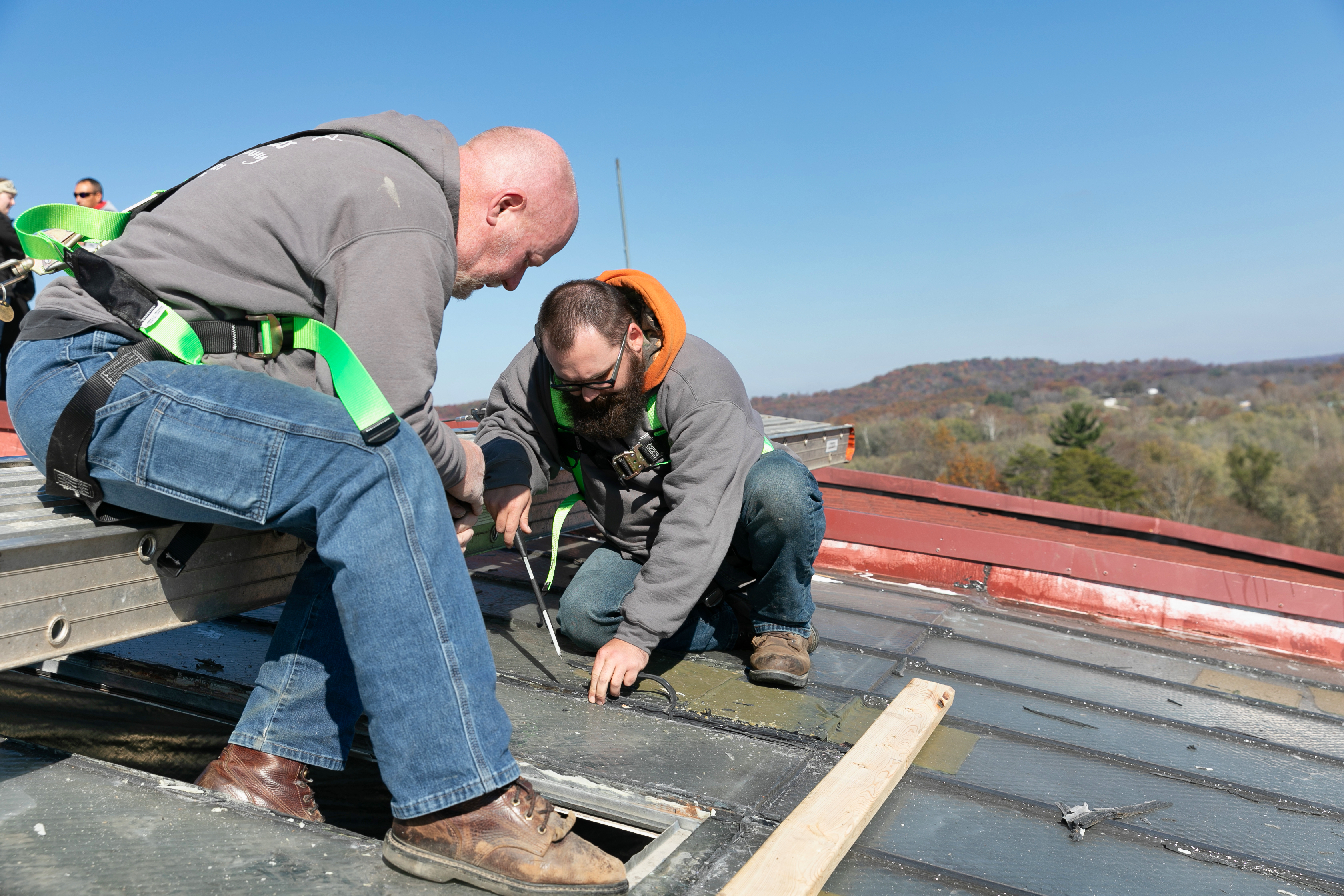 a group of men working on a roof