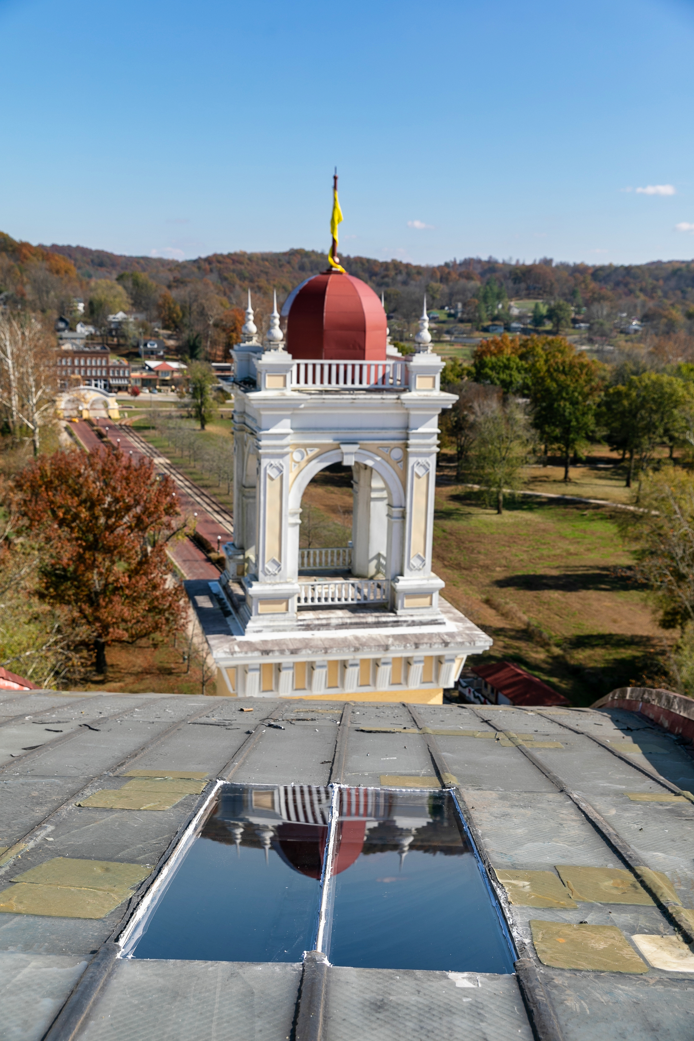 a tower with a red dome and a yellow flag on top