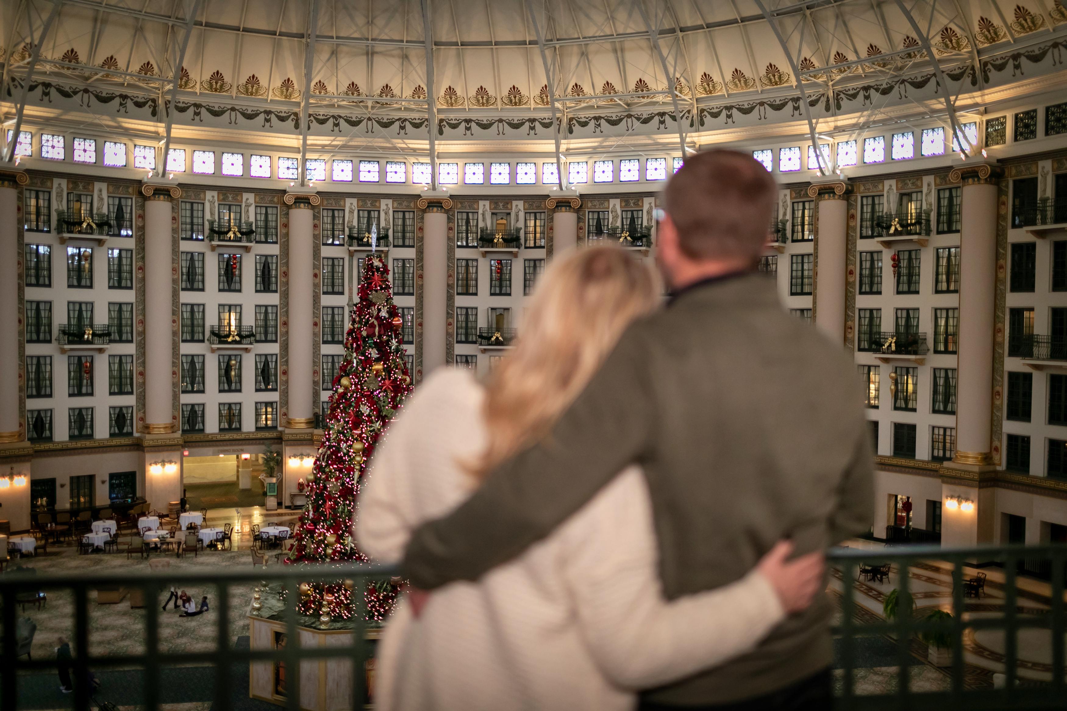 a man and woman hugging in a large building