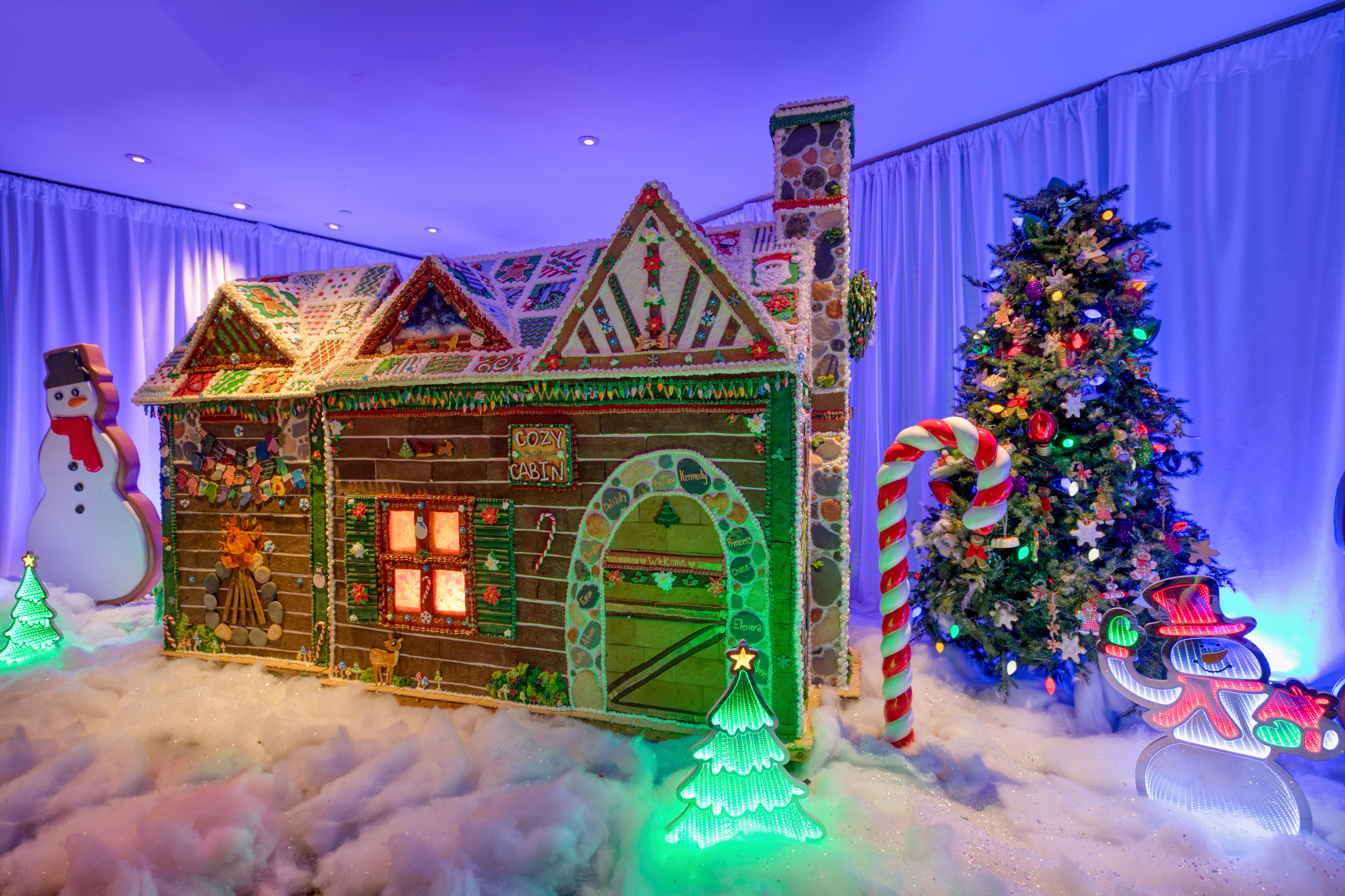 a gingerbread house and a christmas tree