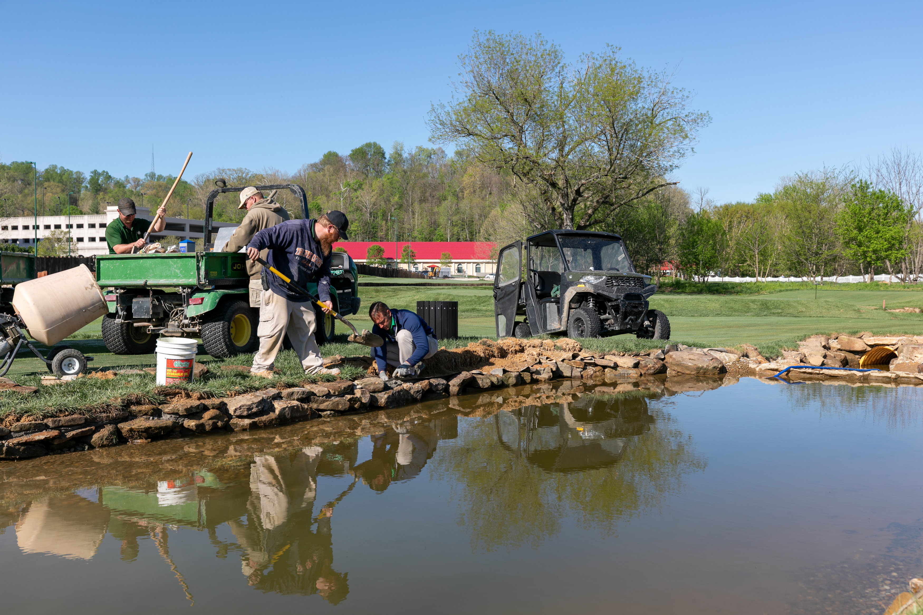 a group of men working on a pond