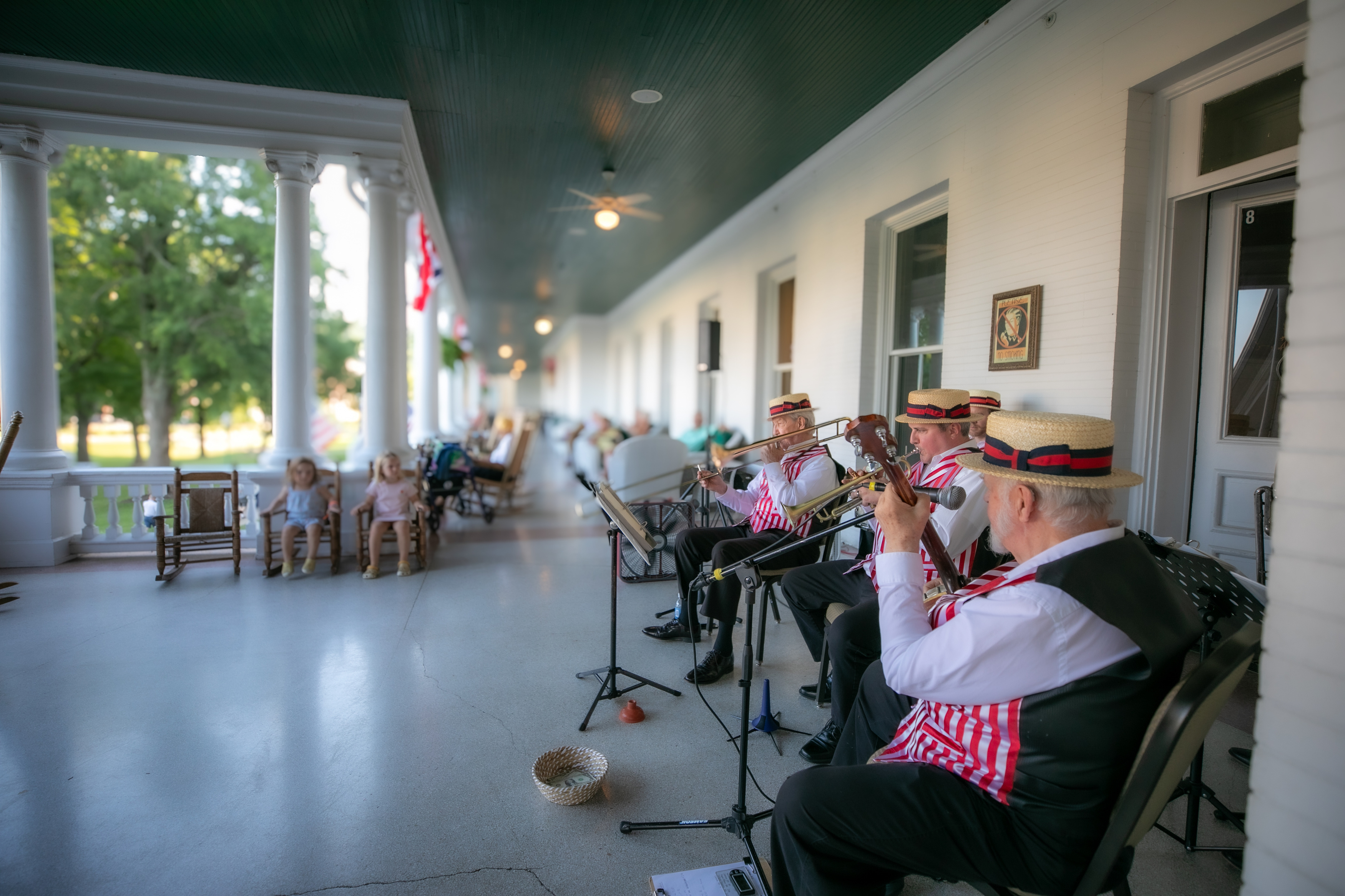 a group of people playing instruments on a porch