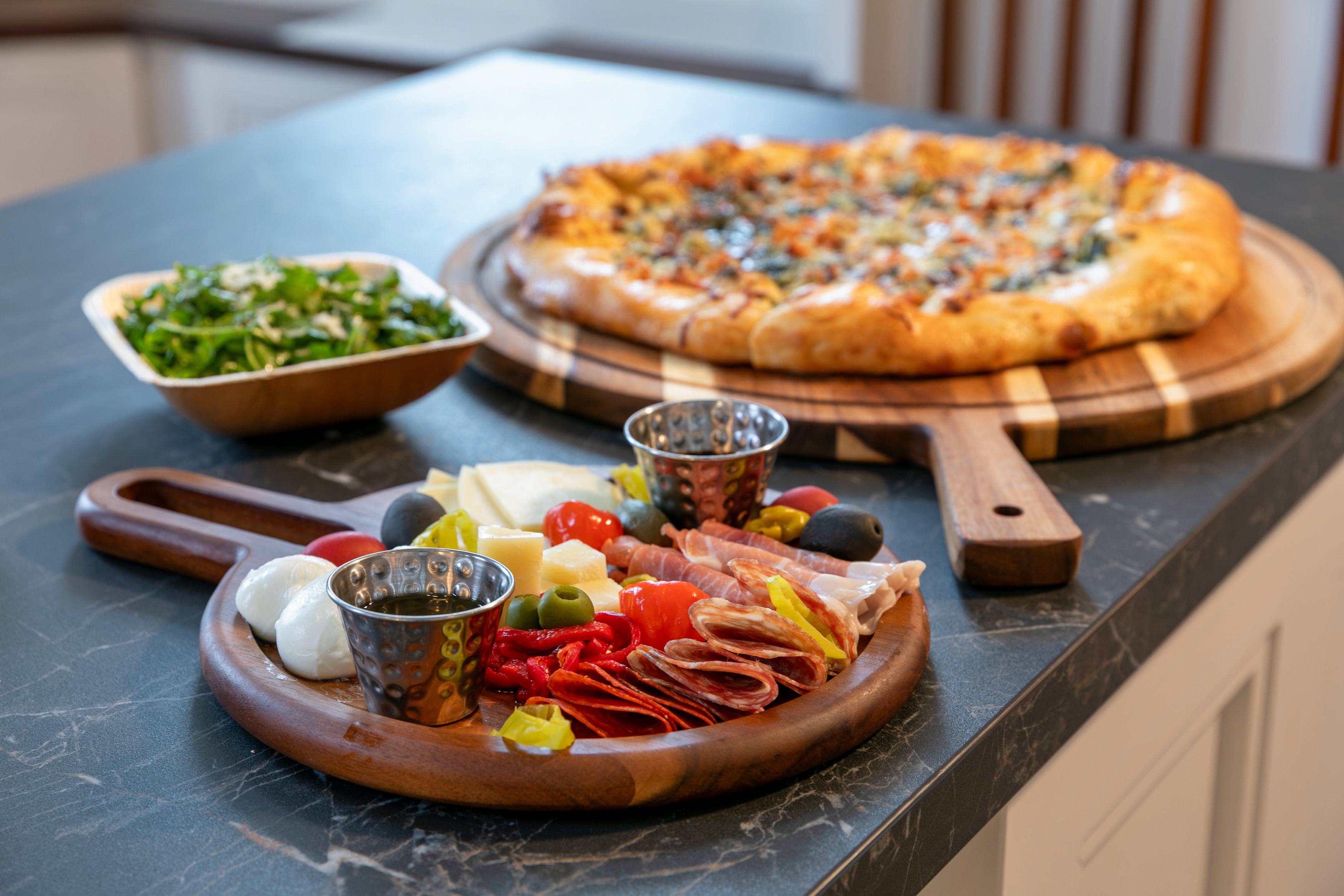 a pizza and food on a counter