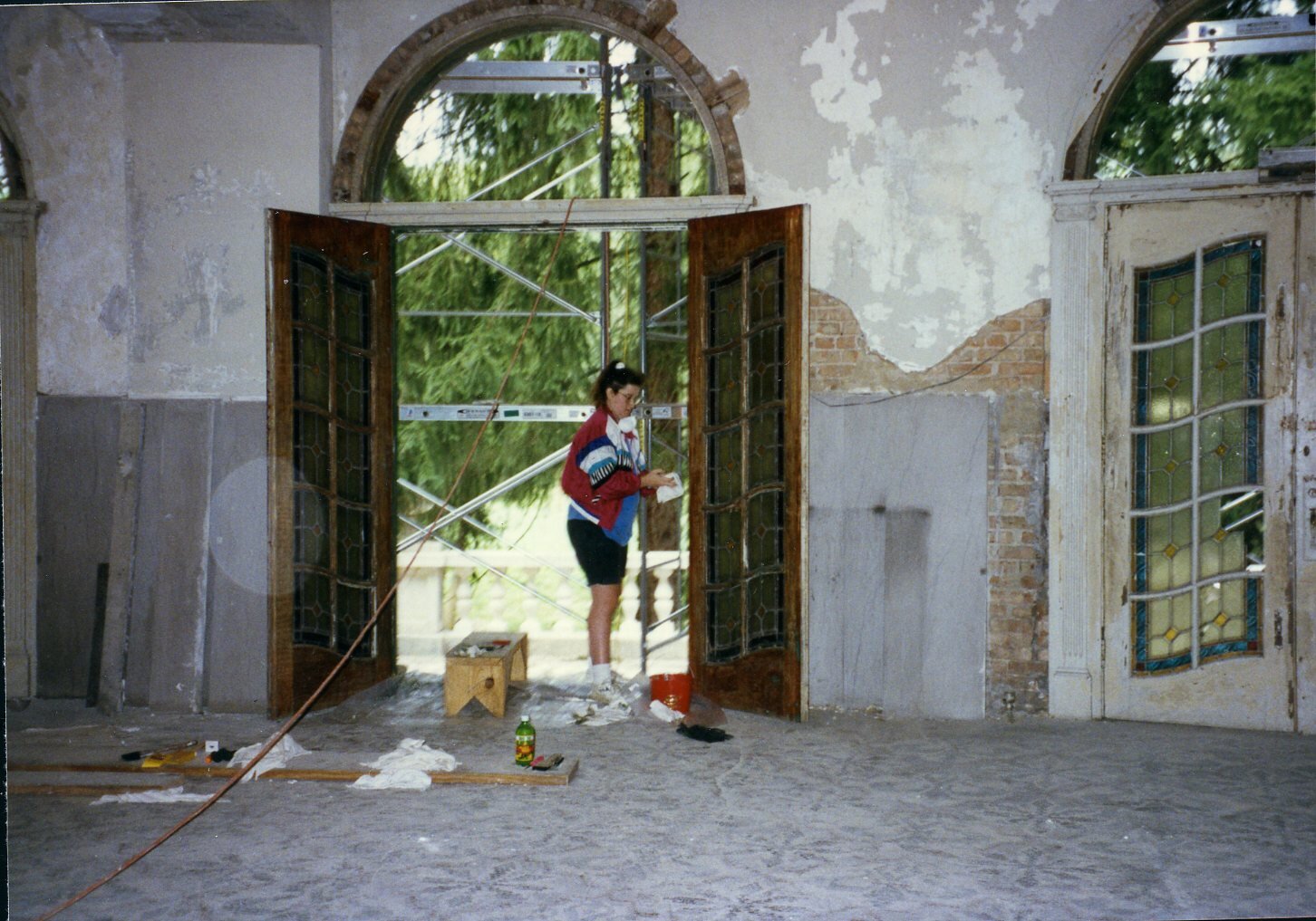 a woman standing in a room with a door open