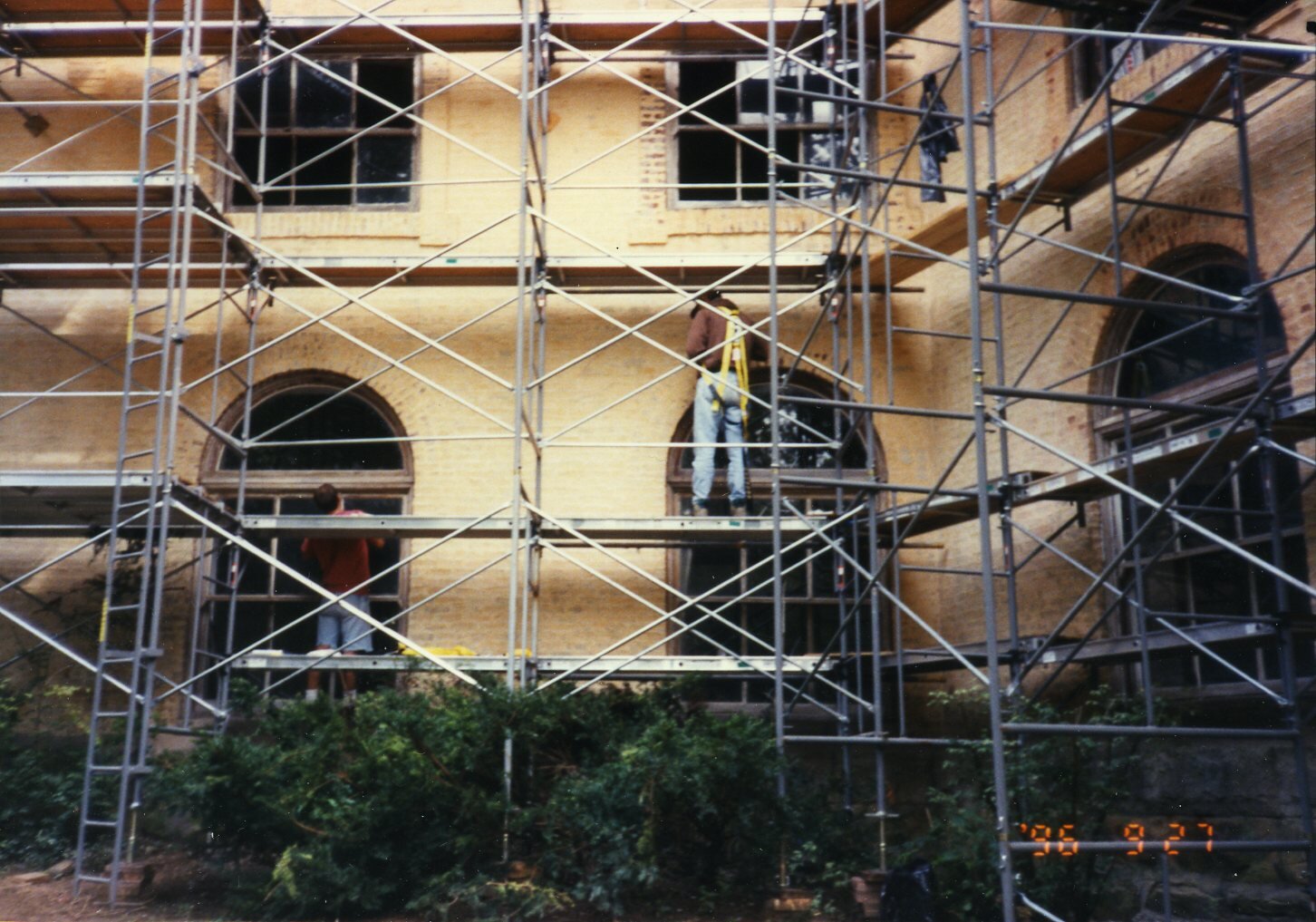 a group of people on scaffolding outside a building