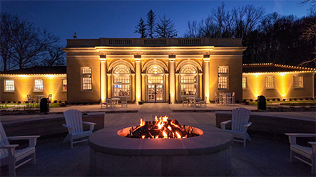 Fire pit burning with chairs around it