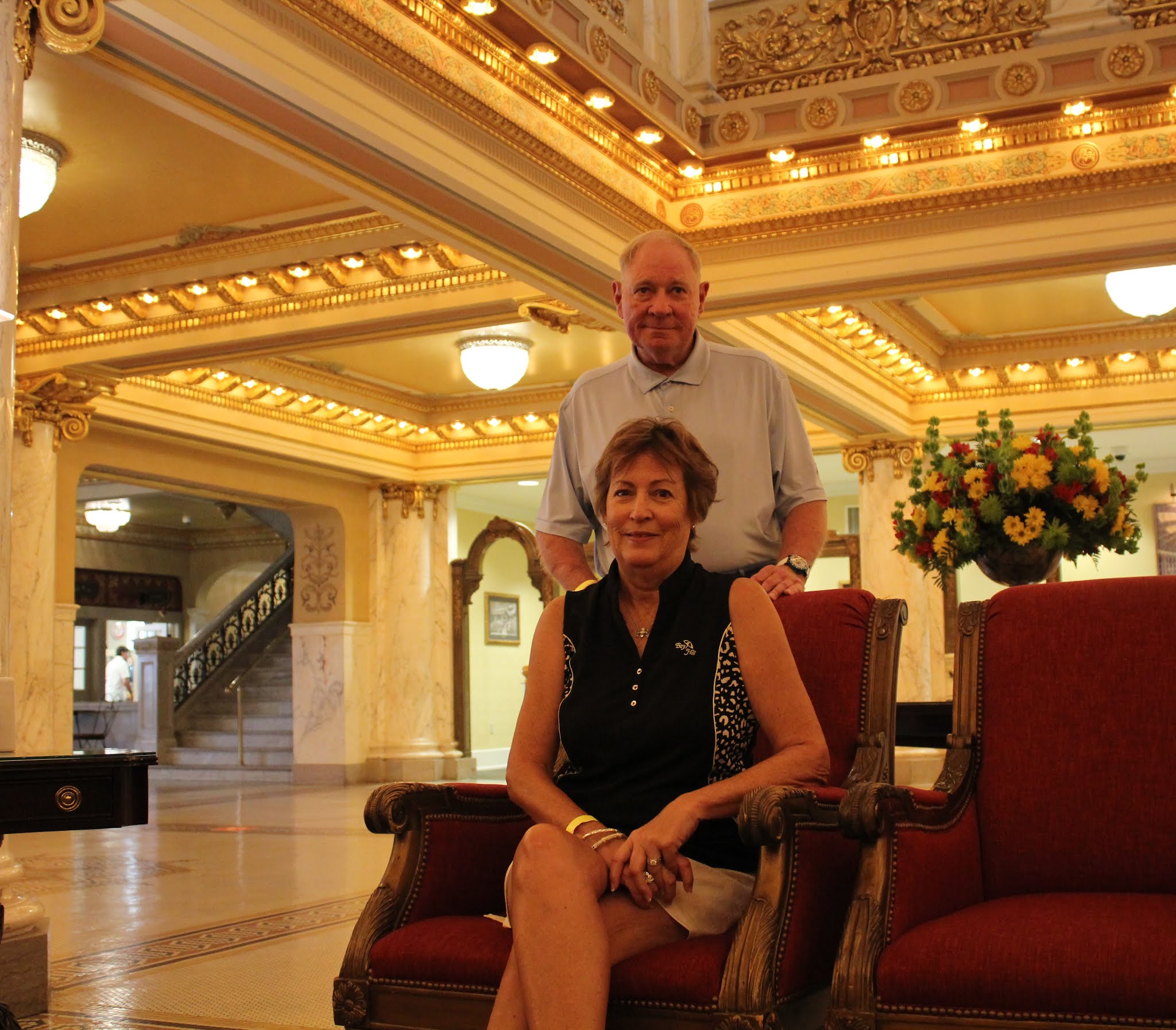 A couple sitting in a hotel lobby