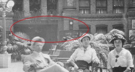 a man and woman sitting on chairs outside a building