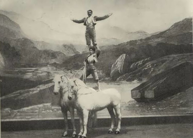 man and women standing on horses