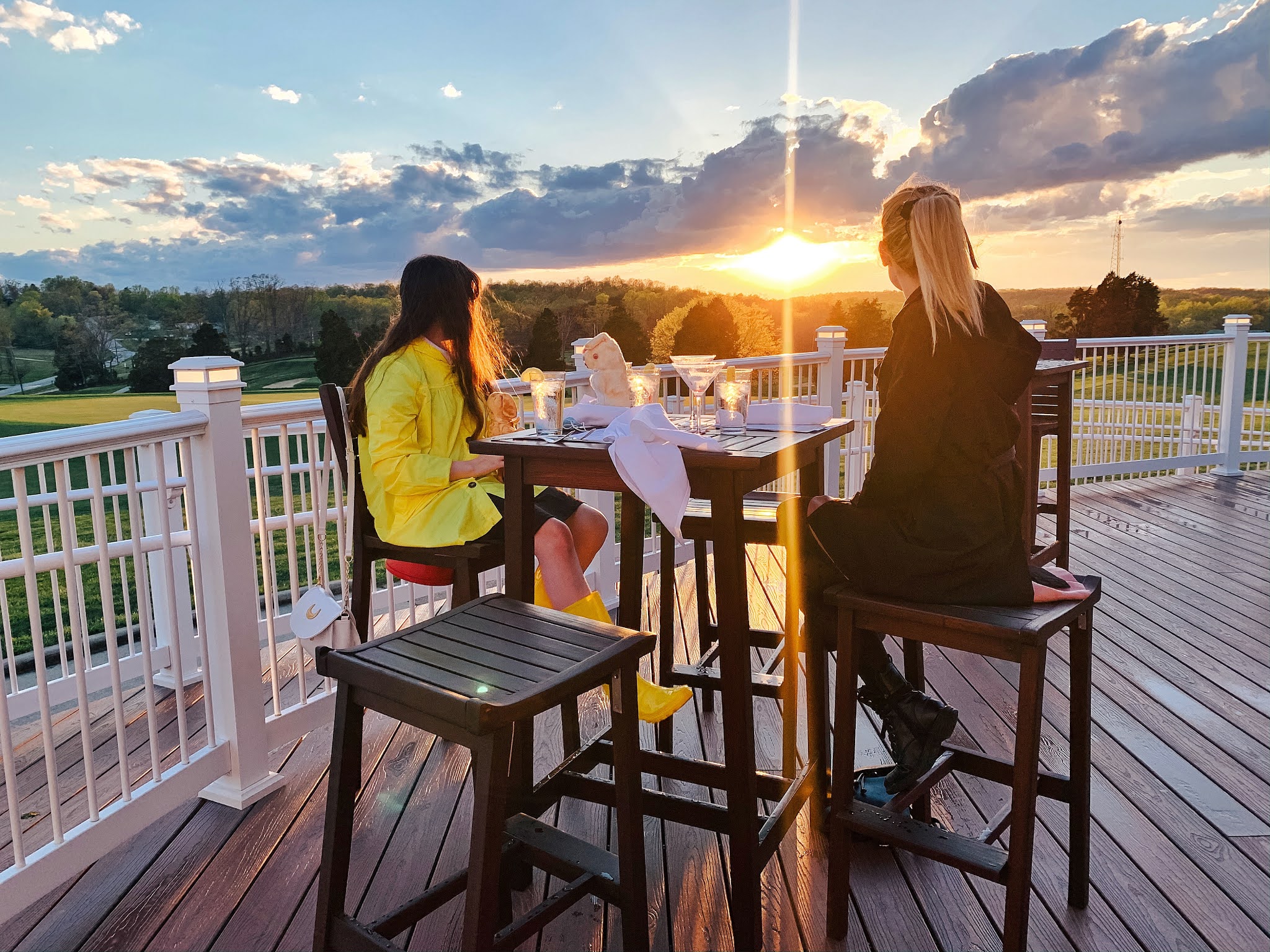 Two women dining at a table outside