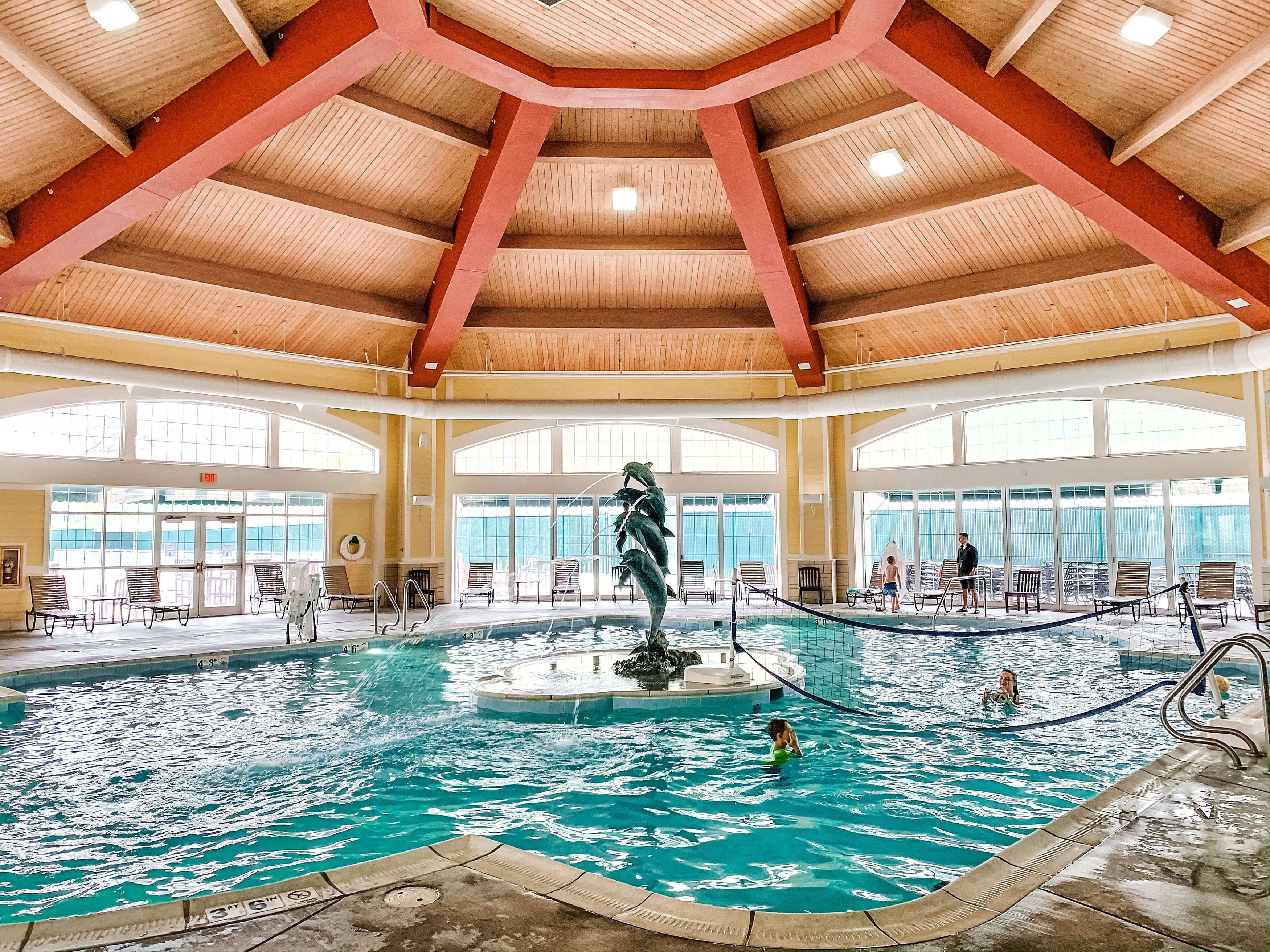 a swimming pool with a statue in it