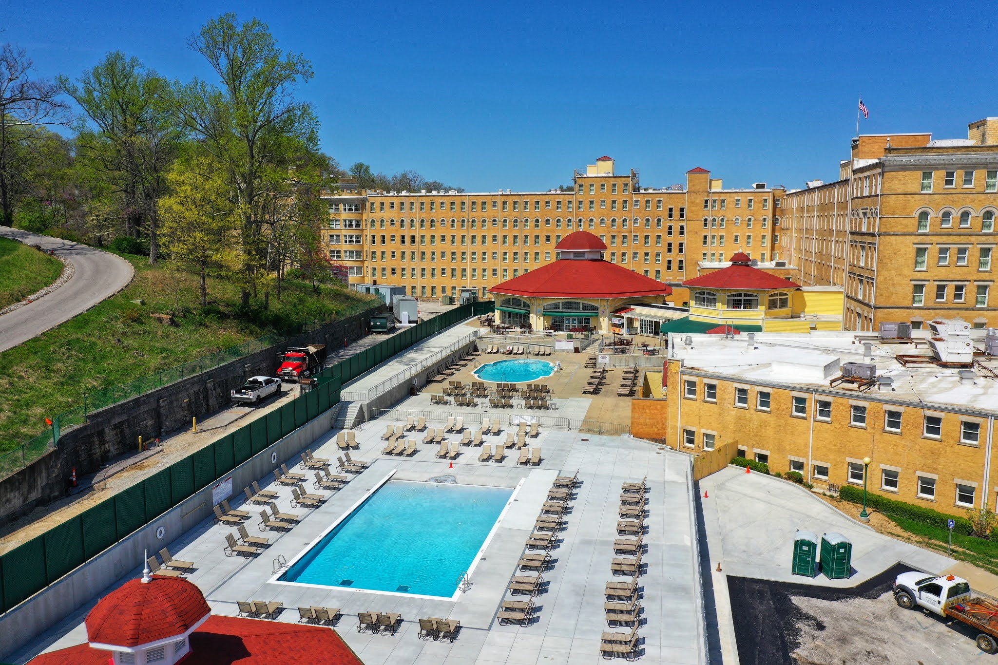 An aerial view of a large hotel and pool