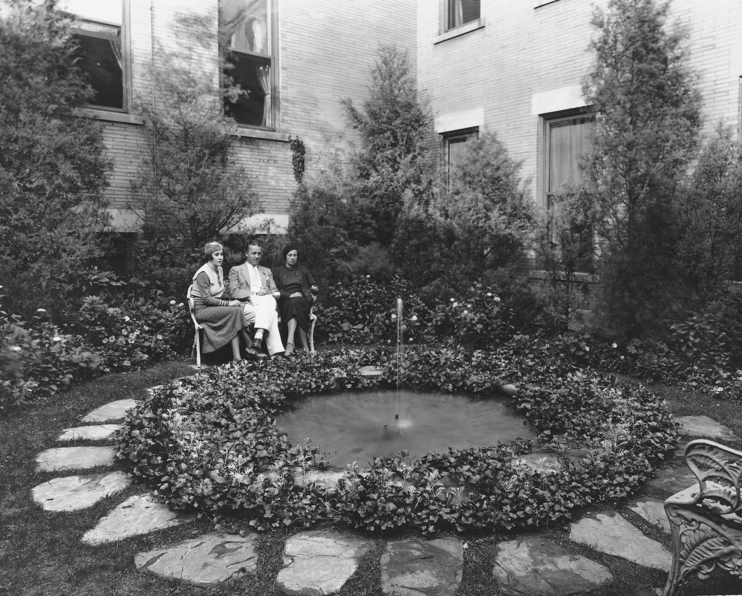 a group of people sitting in a garden