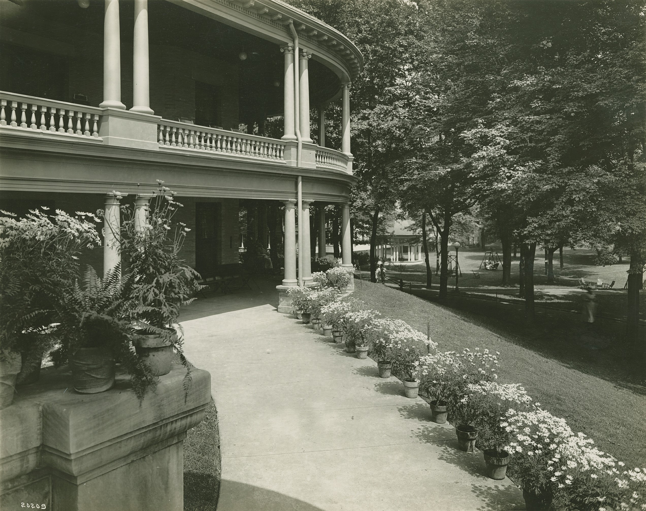 a large building with a porch and a walkway