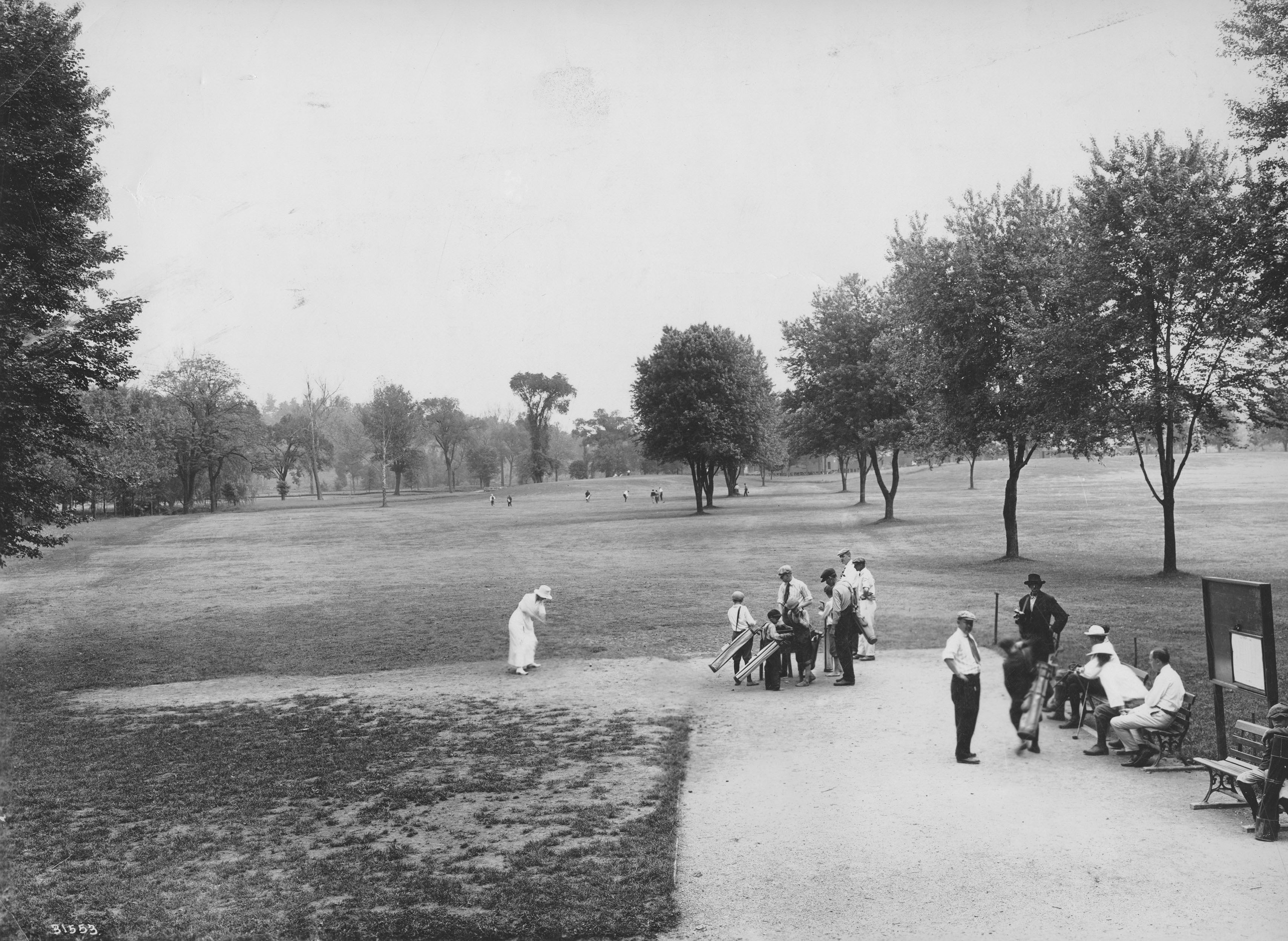 Black and white photo of people on a golf course