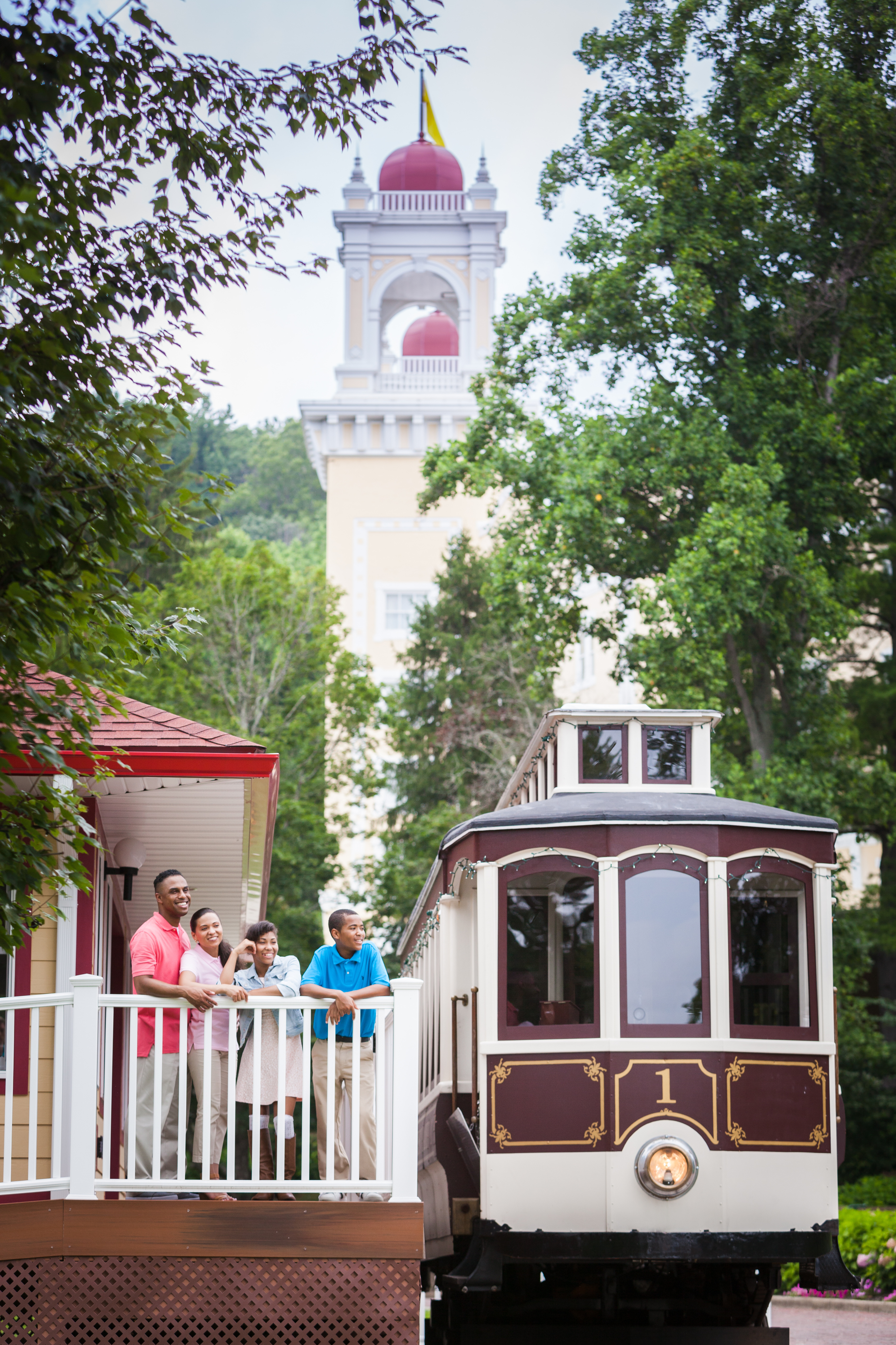 a group of people standing on a rail in front of a train