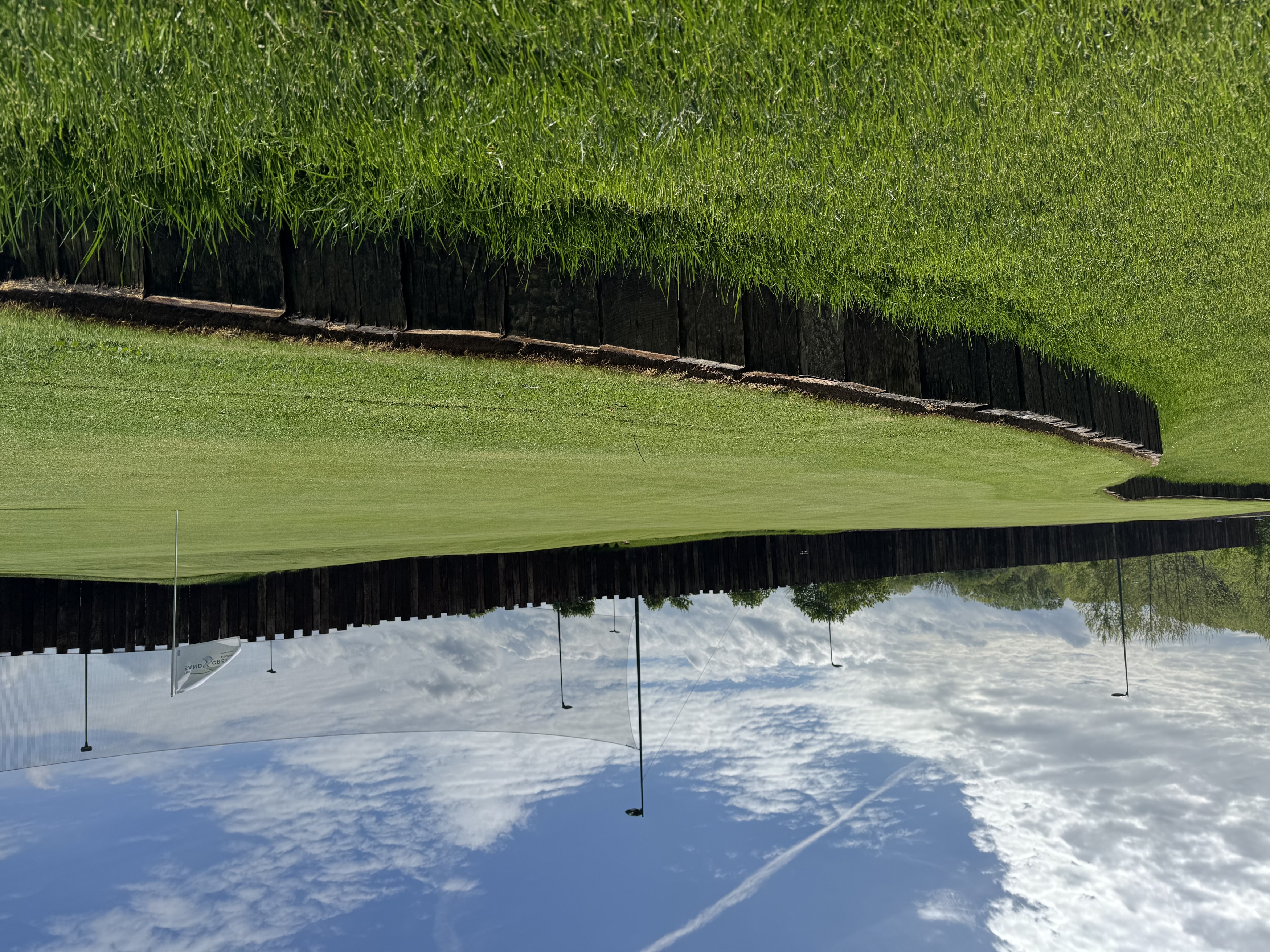 a grass field with a white flag