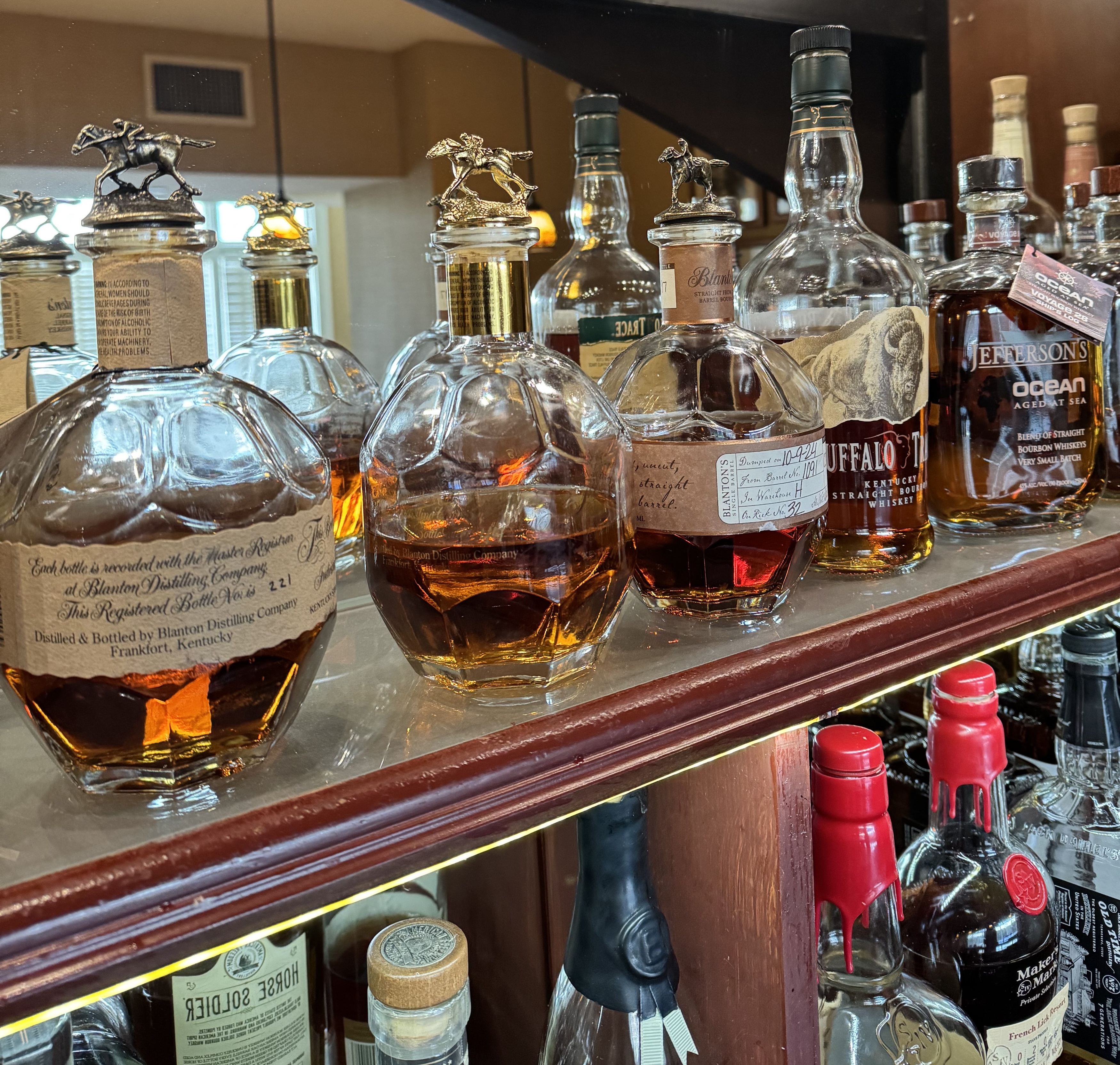 a group of bottles of alcohol on a shelf