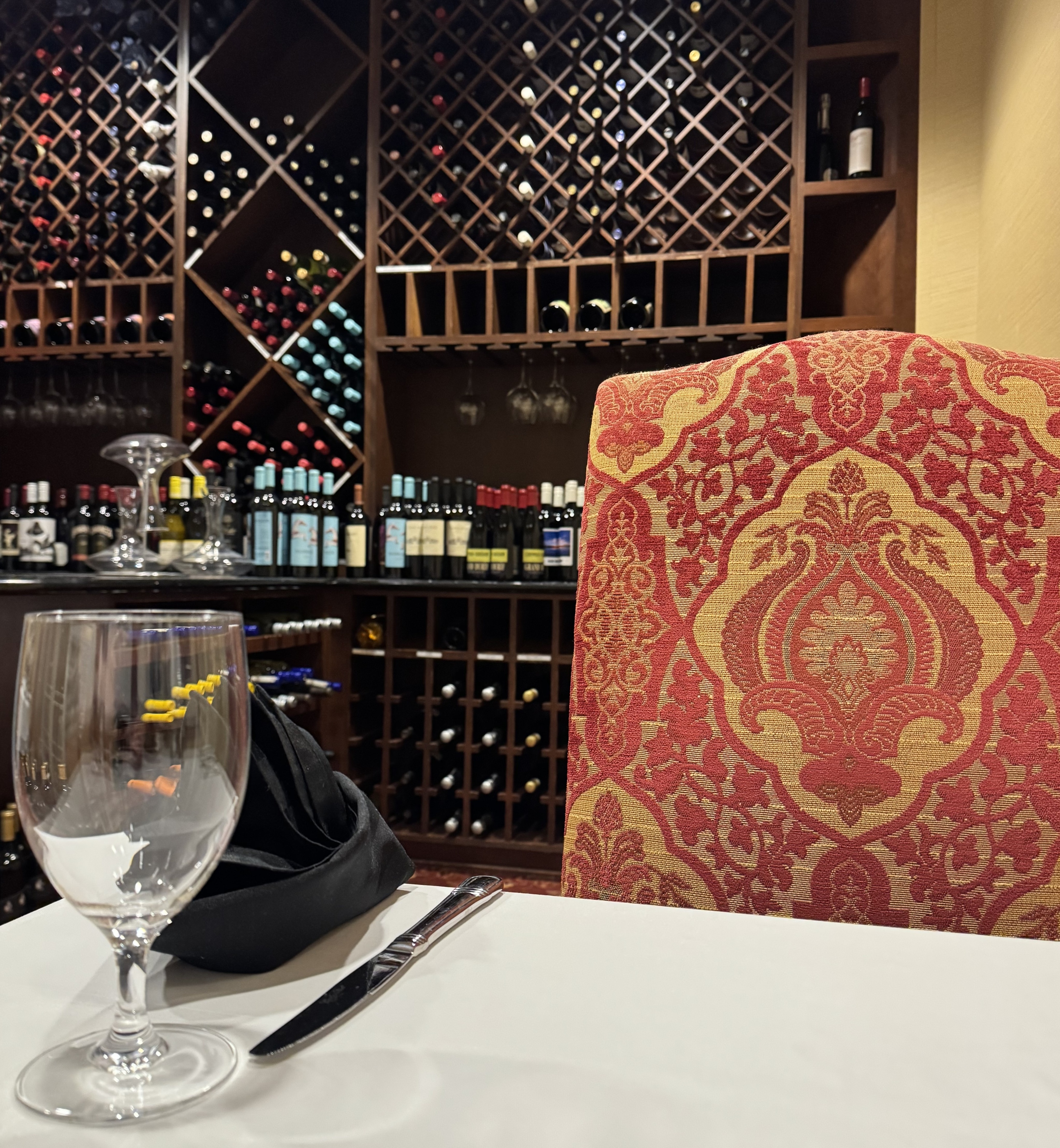 A table with wine bottles in the background