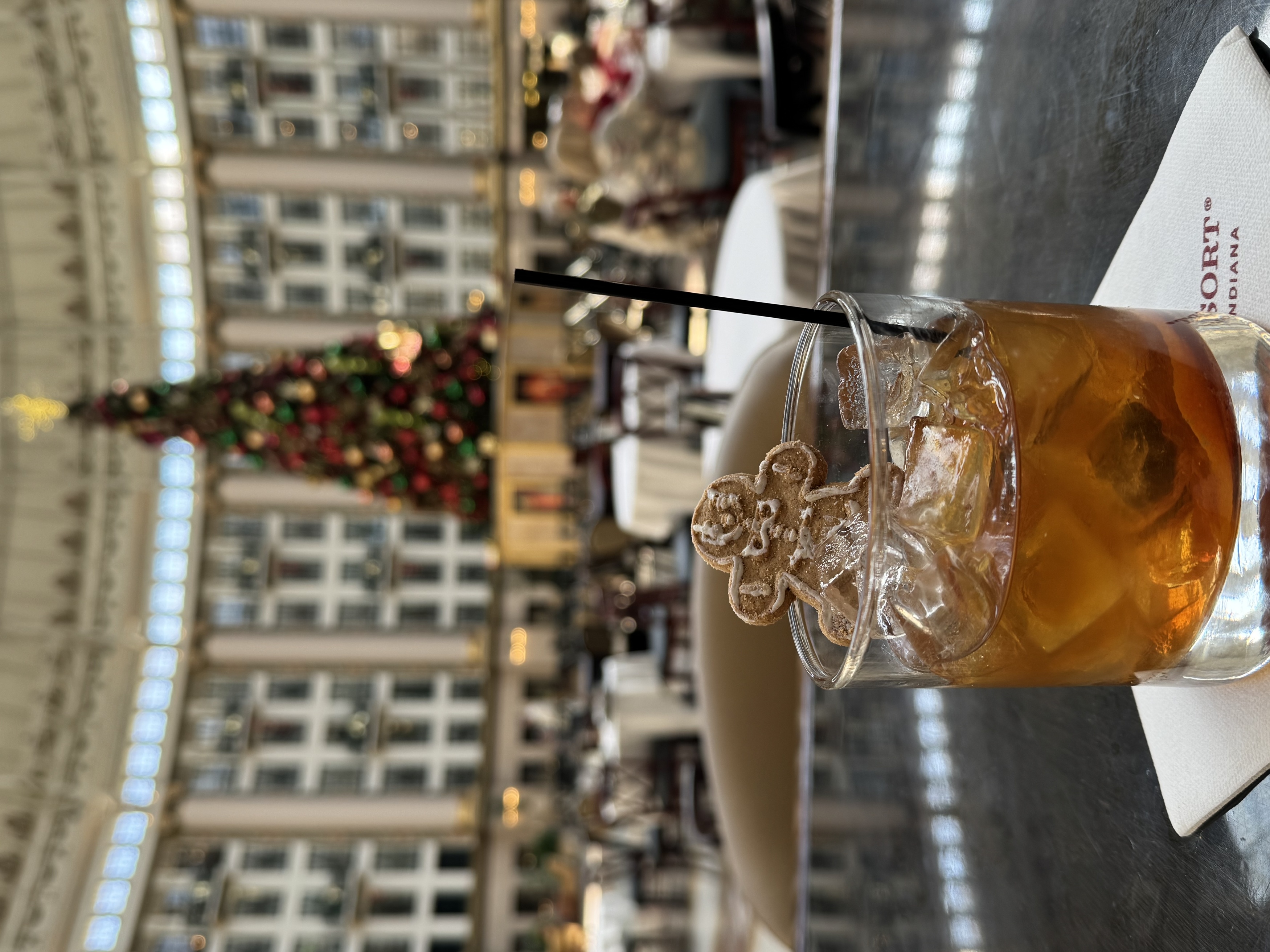 a glass with ice and a gingerbread man on it