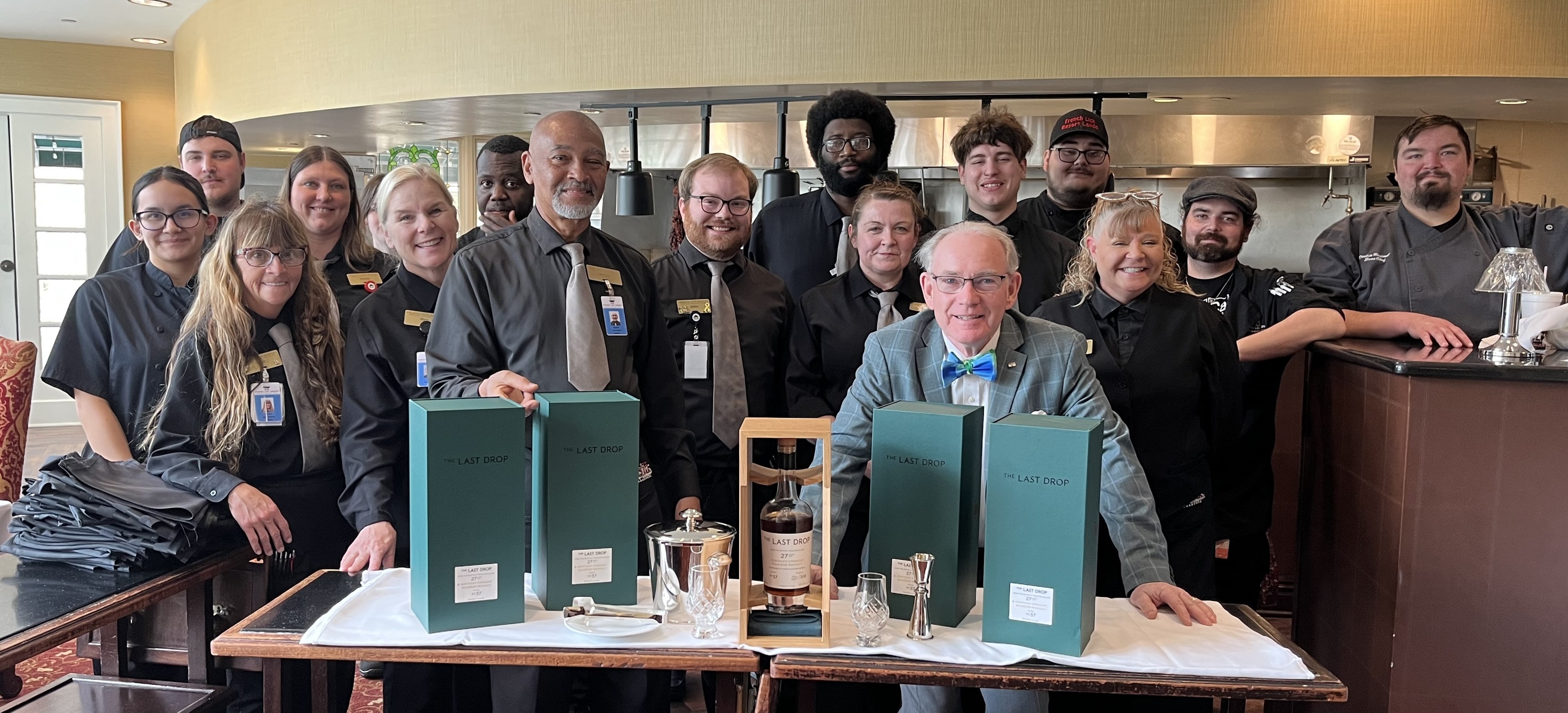 a group of people standing around a table with boxes