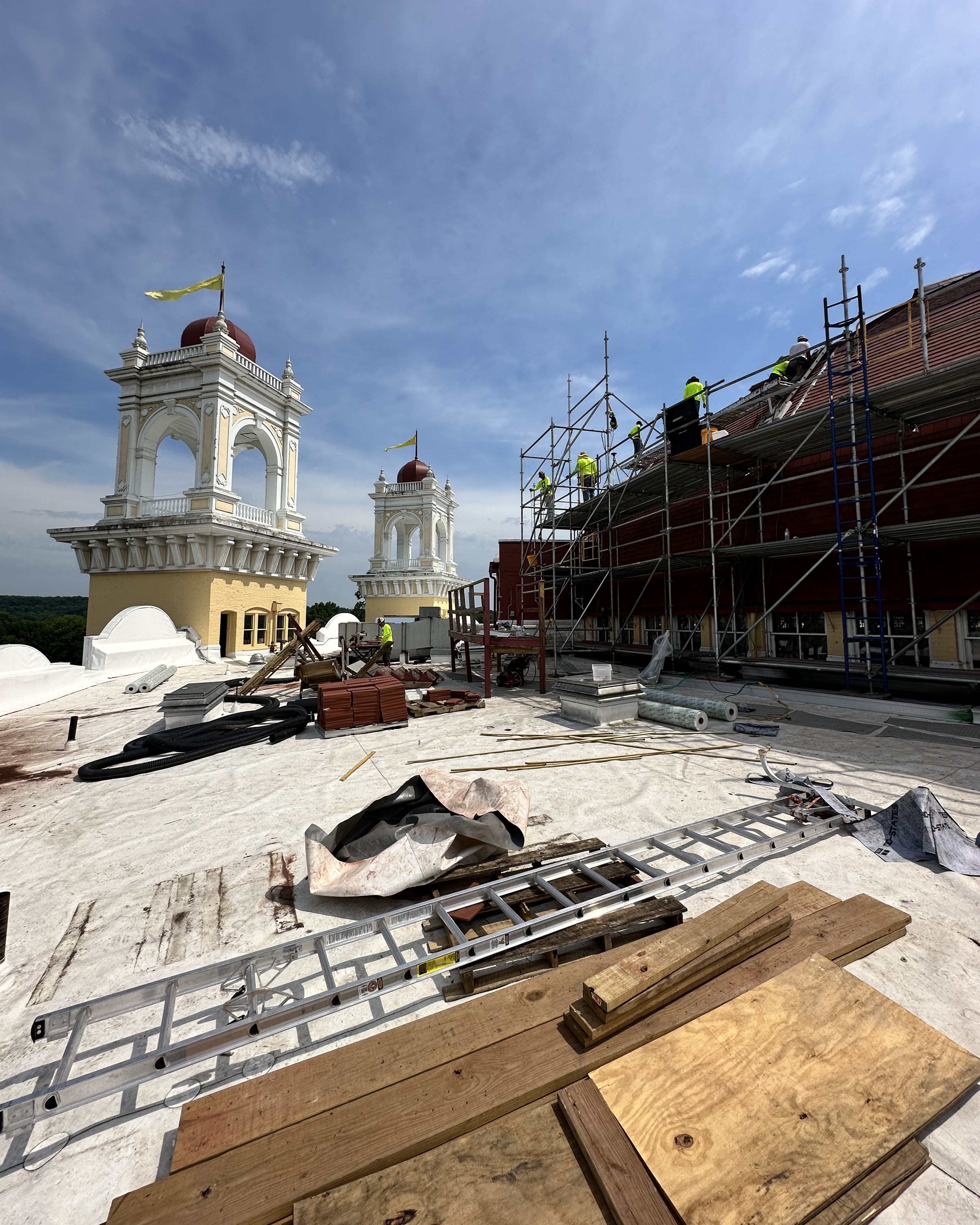 a building under construction with scaffolding and people on it