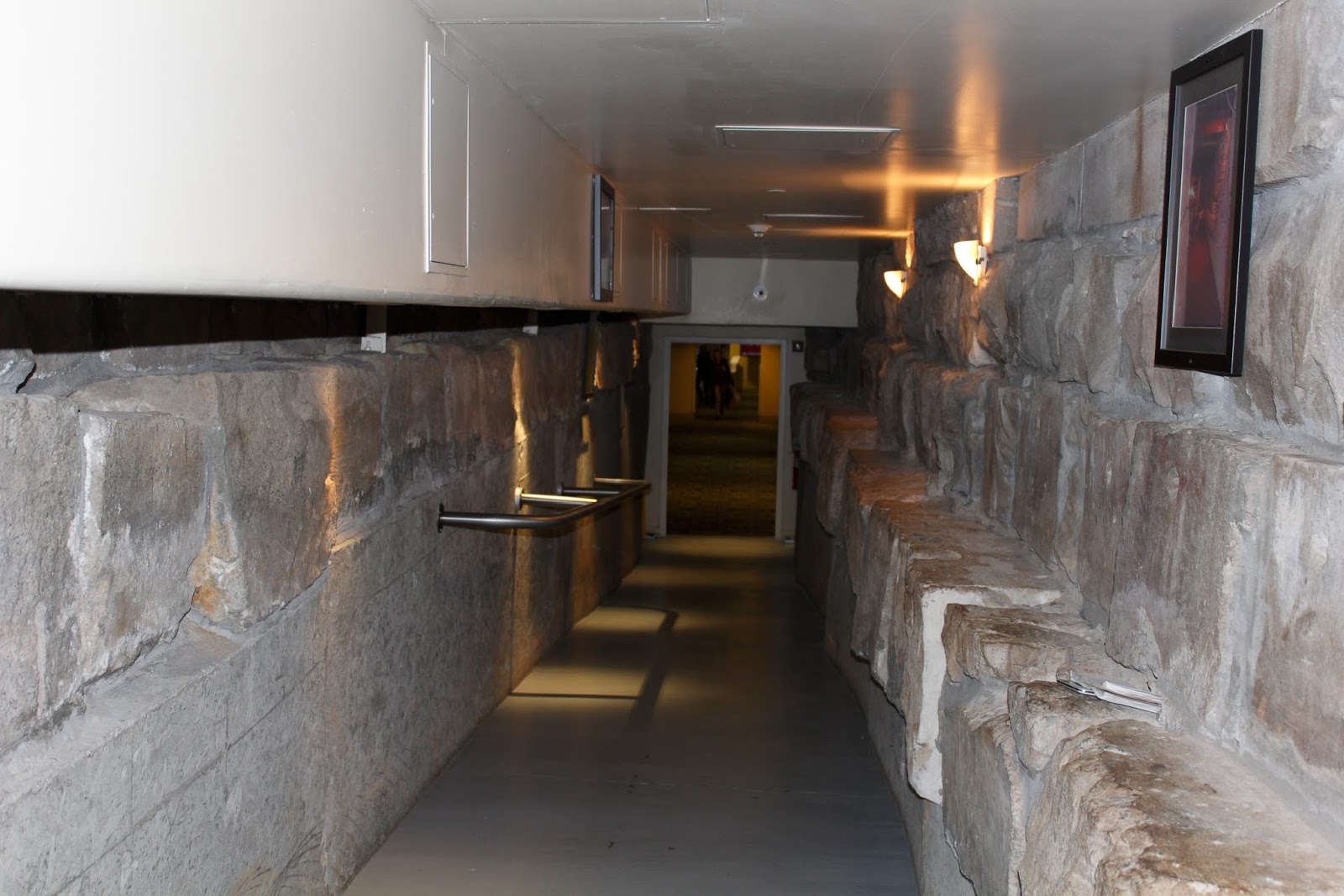 a hallway with a stone wall