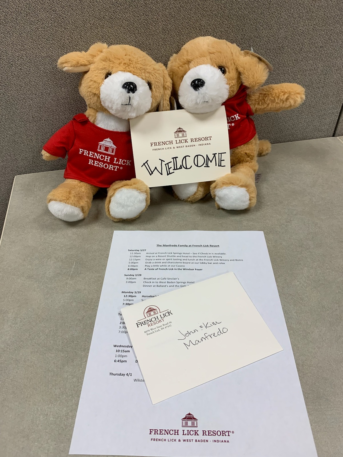 two stuffed animals next to a piece of paper