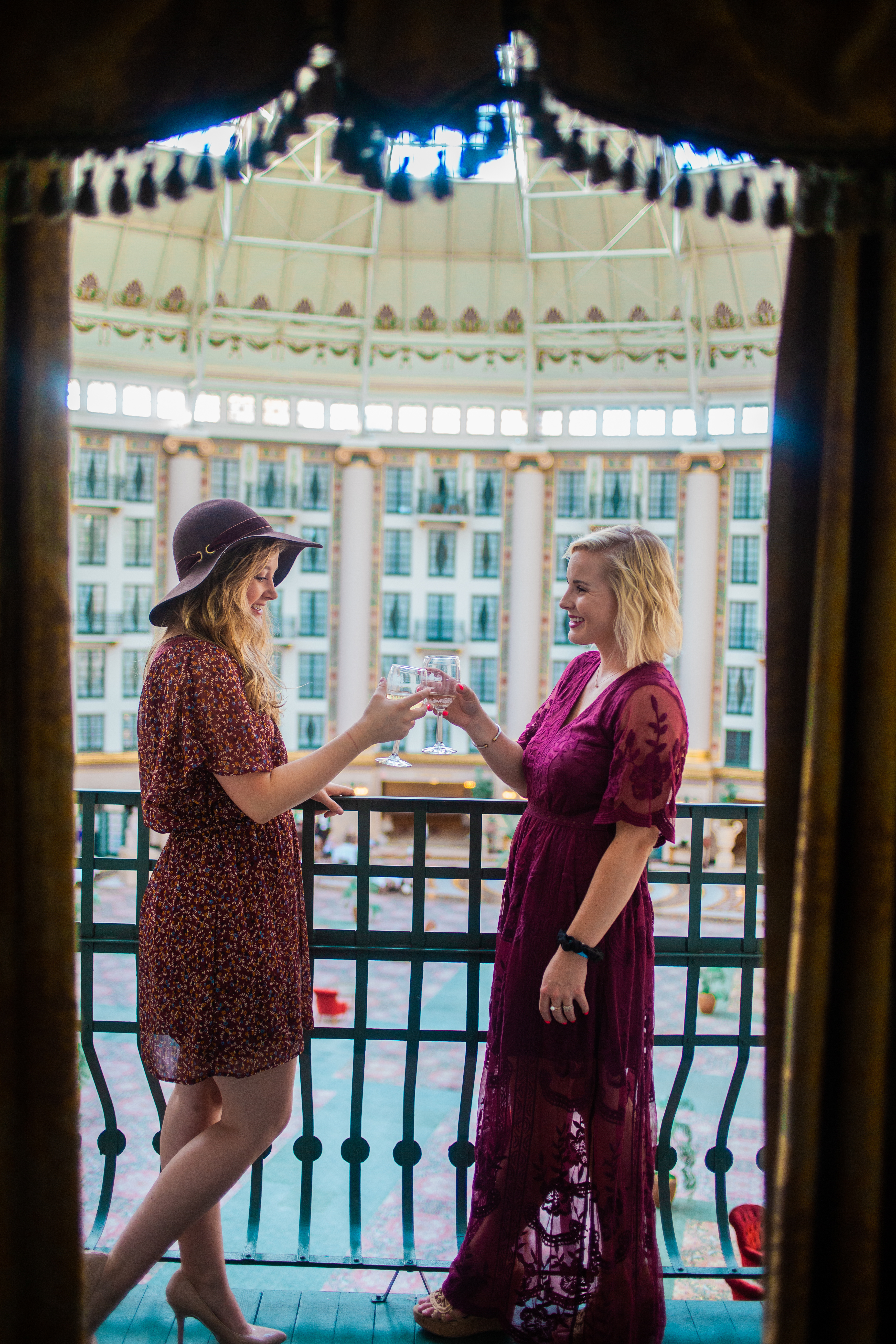 two women holding glasses of wine