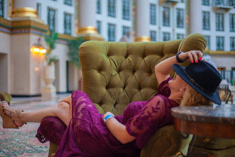 woman on chair with hat over face