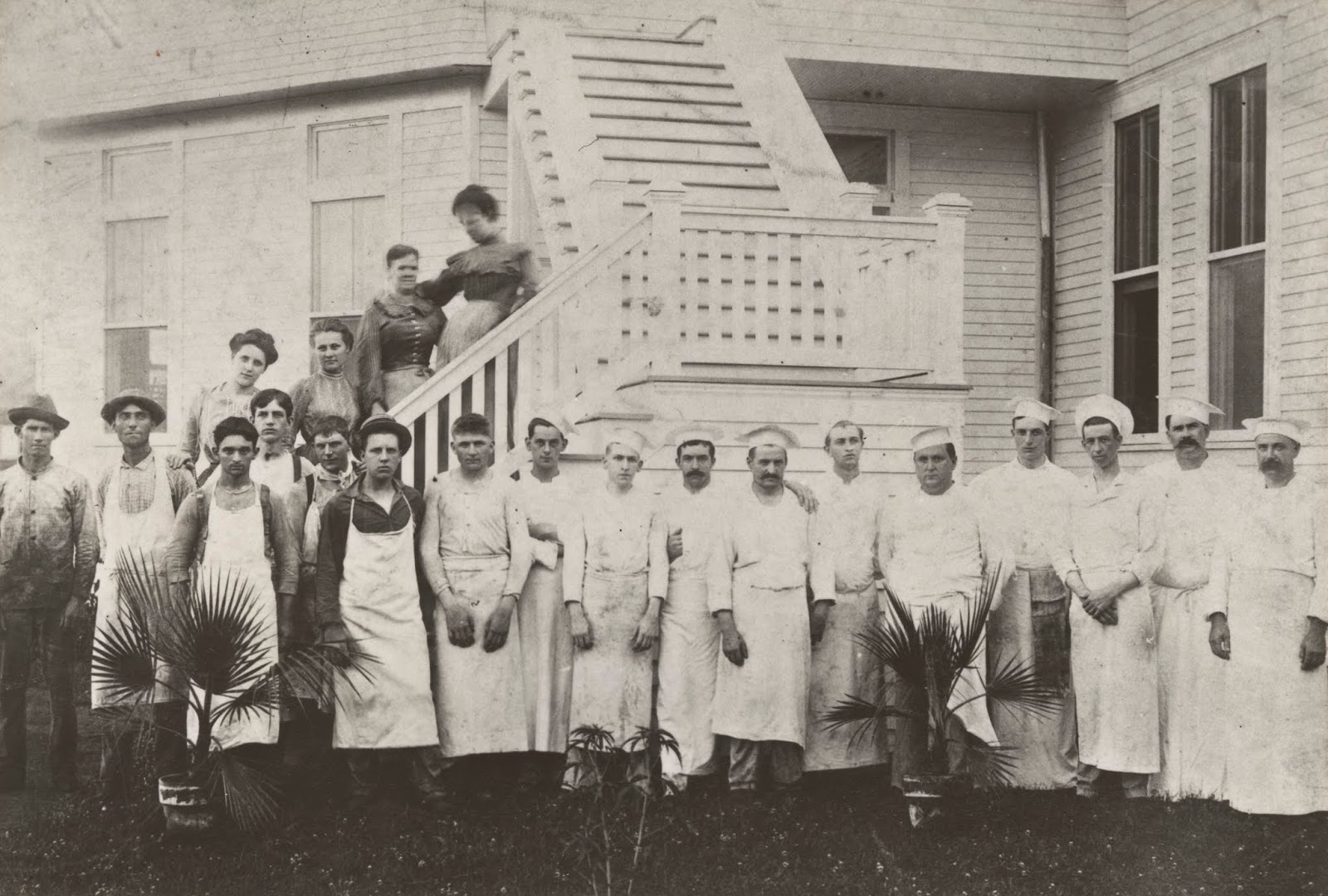 a group of people standing outside a house