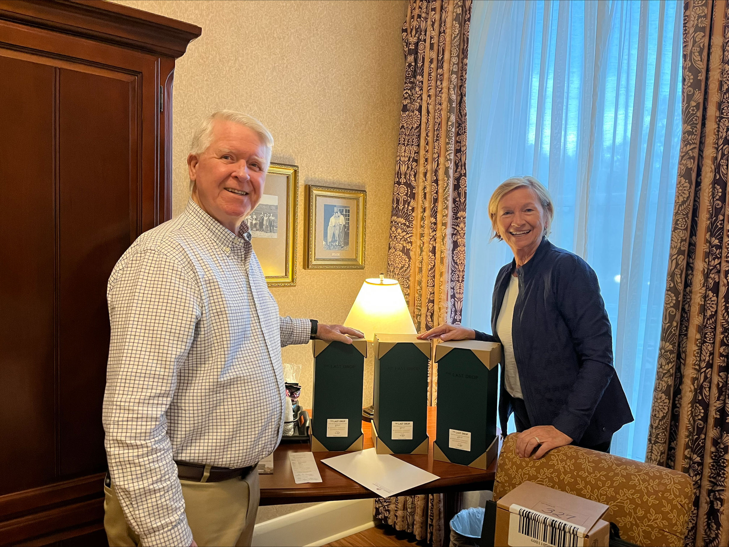 a man and woman standing next to a table with boxes