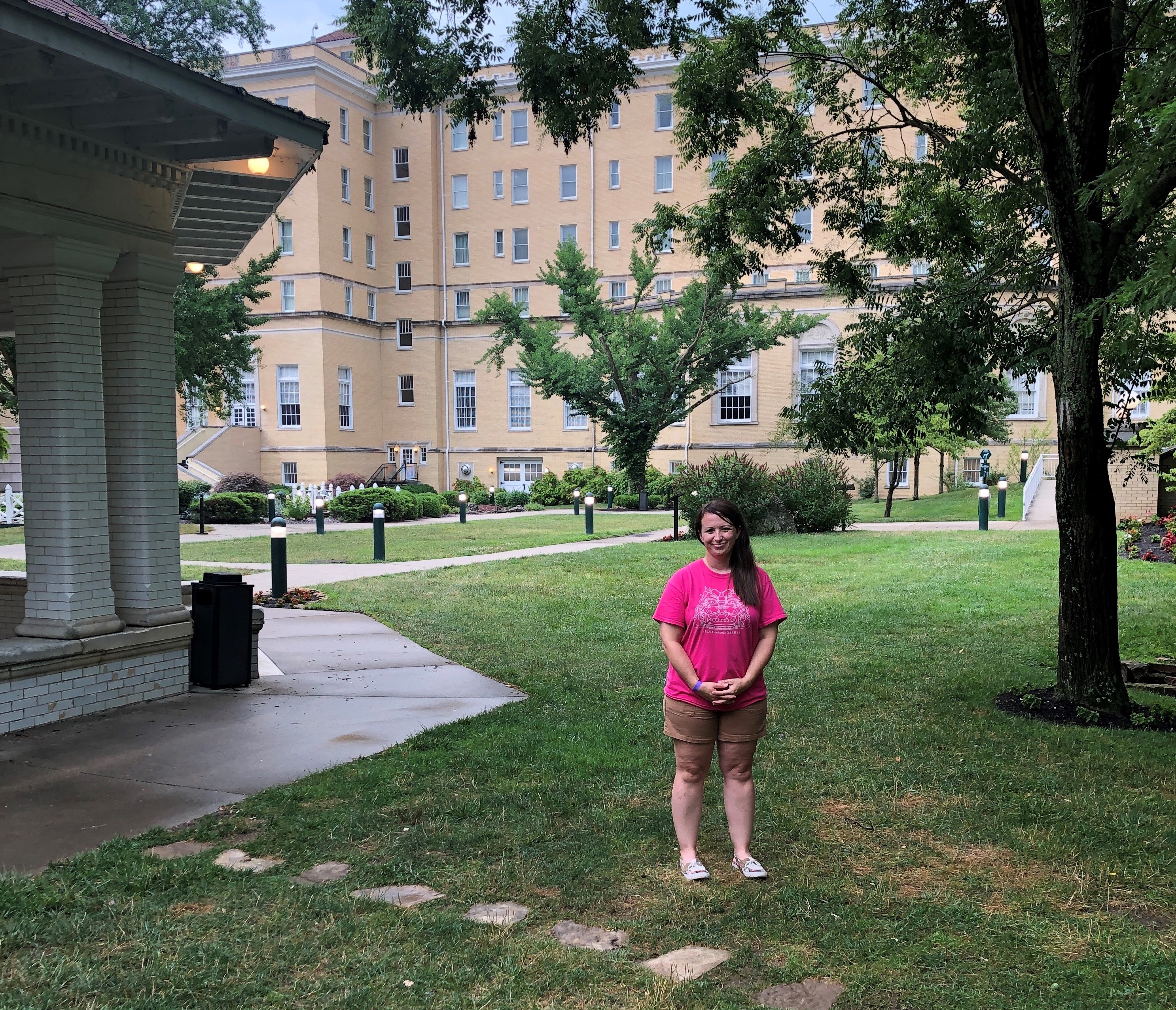 a woman standing in a grassy area