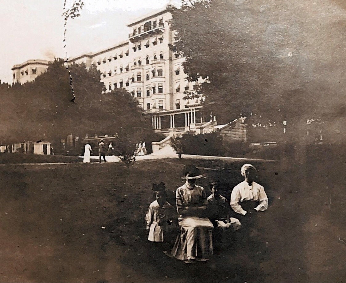 a group of people sitting in front of a large building