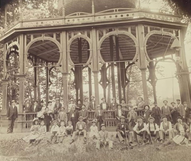 people in front of old neptune spring