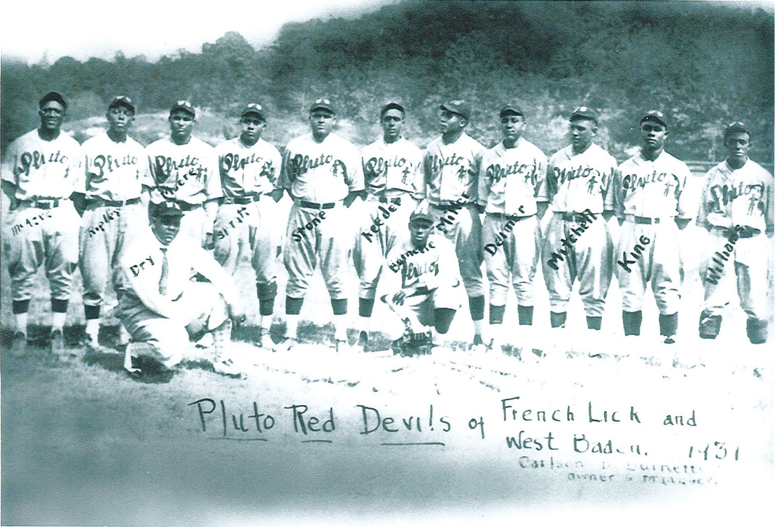 a group of baseball players posing for a photo