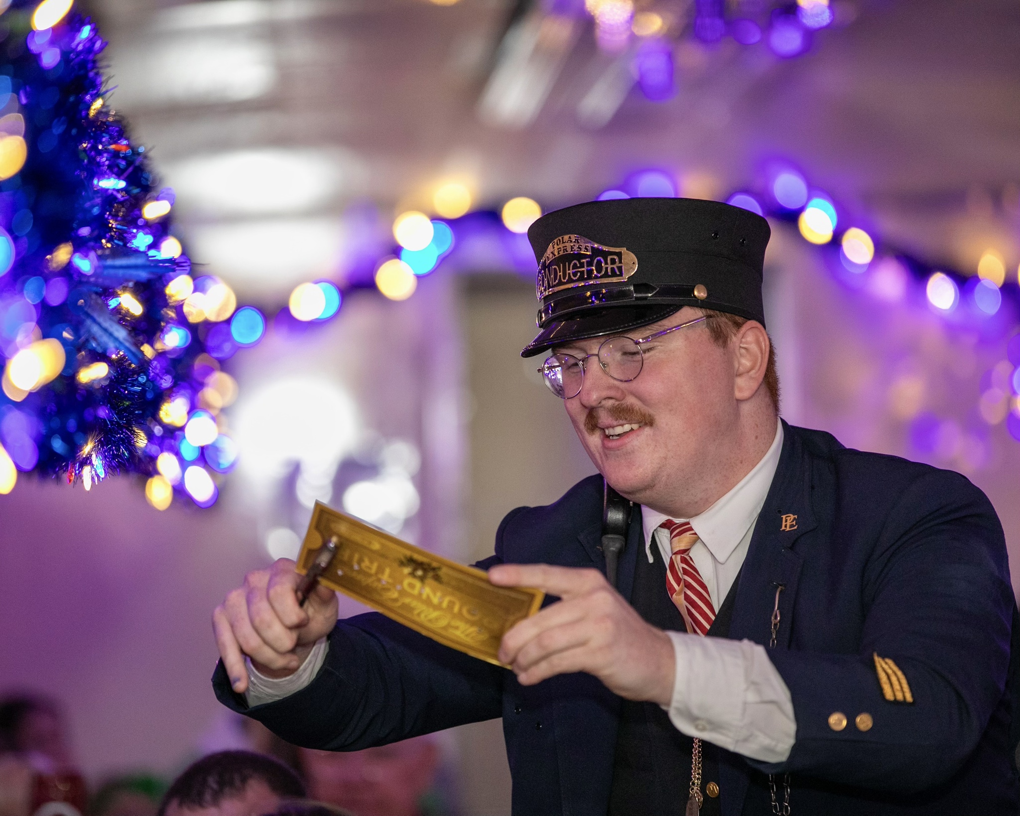 a man wearing a uniform and holding a gold sign