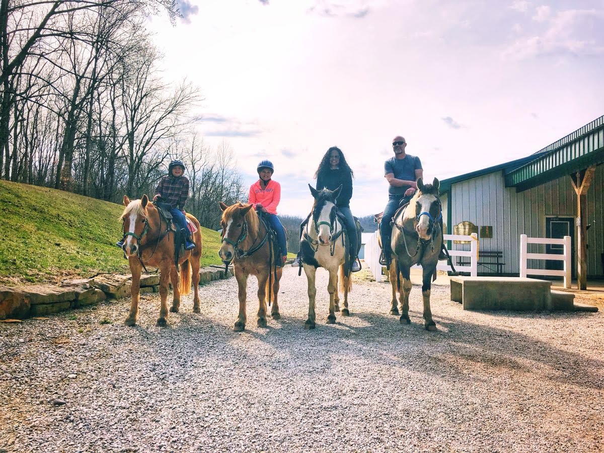 a group of people riding horses